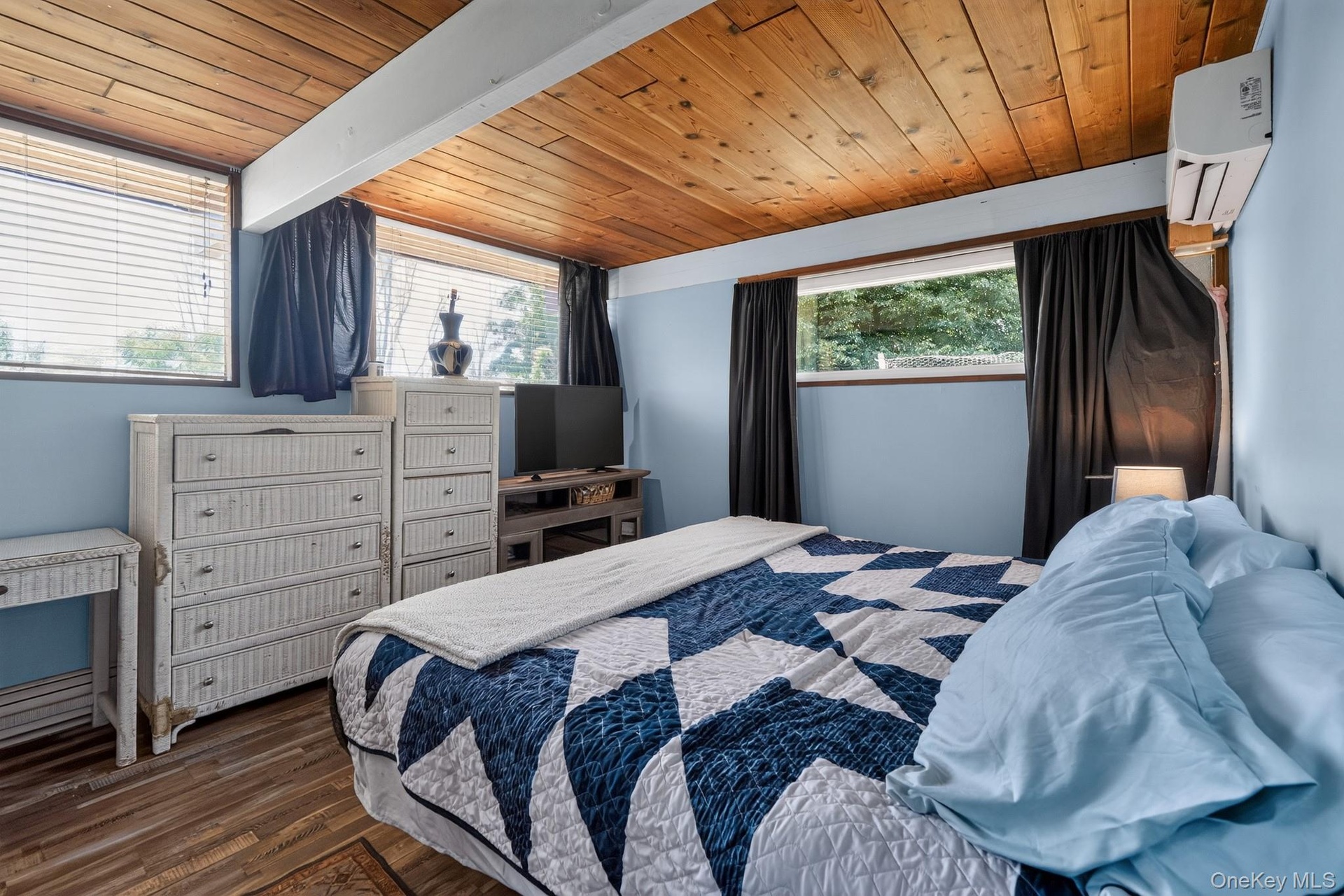 Wood-plank ceiling with exposed beams