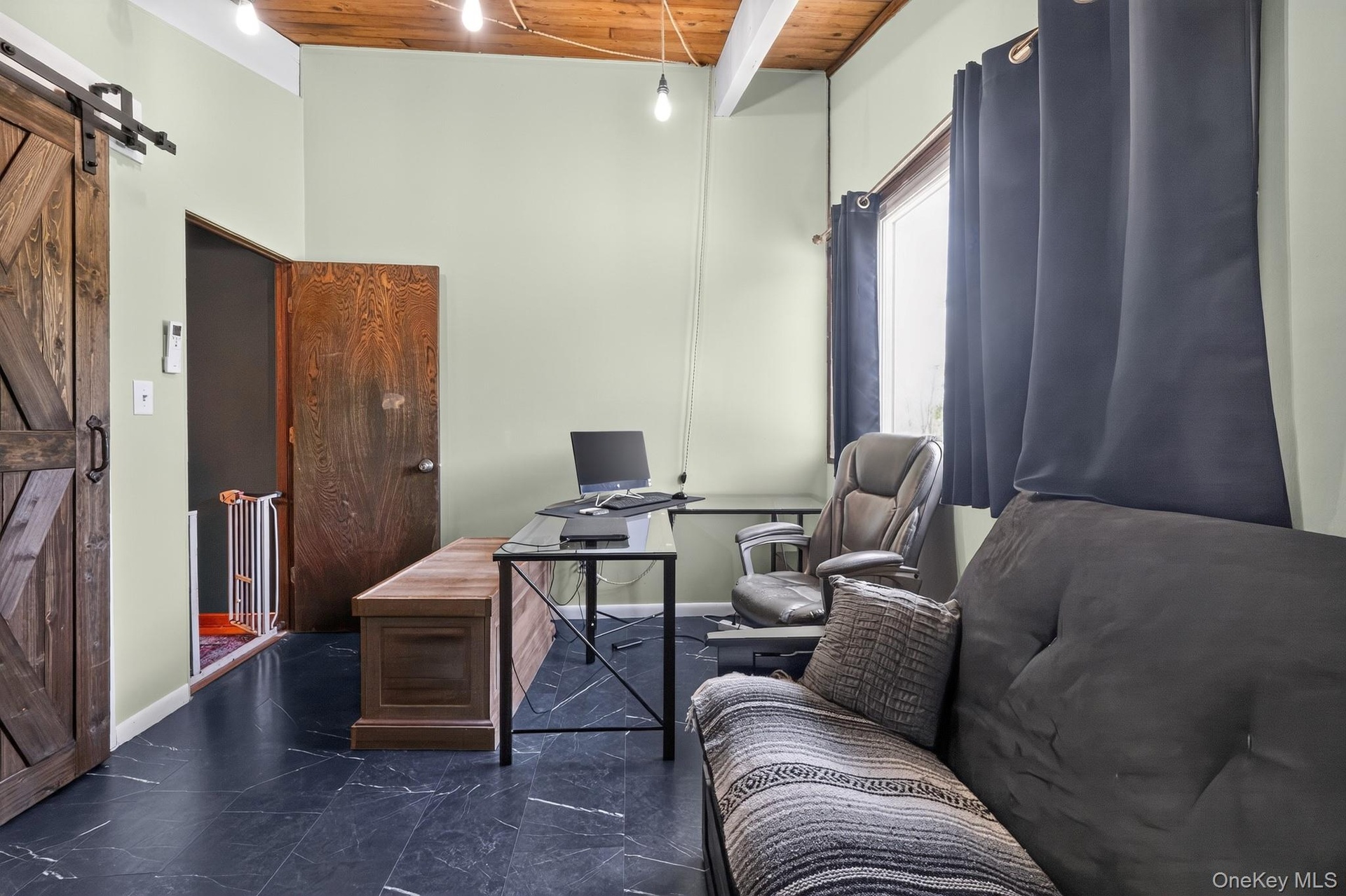 Room featuring wood-finish ceiling, exposed beams, and a barn door