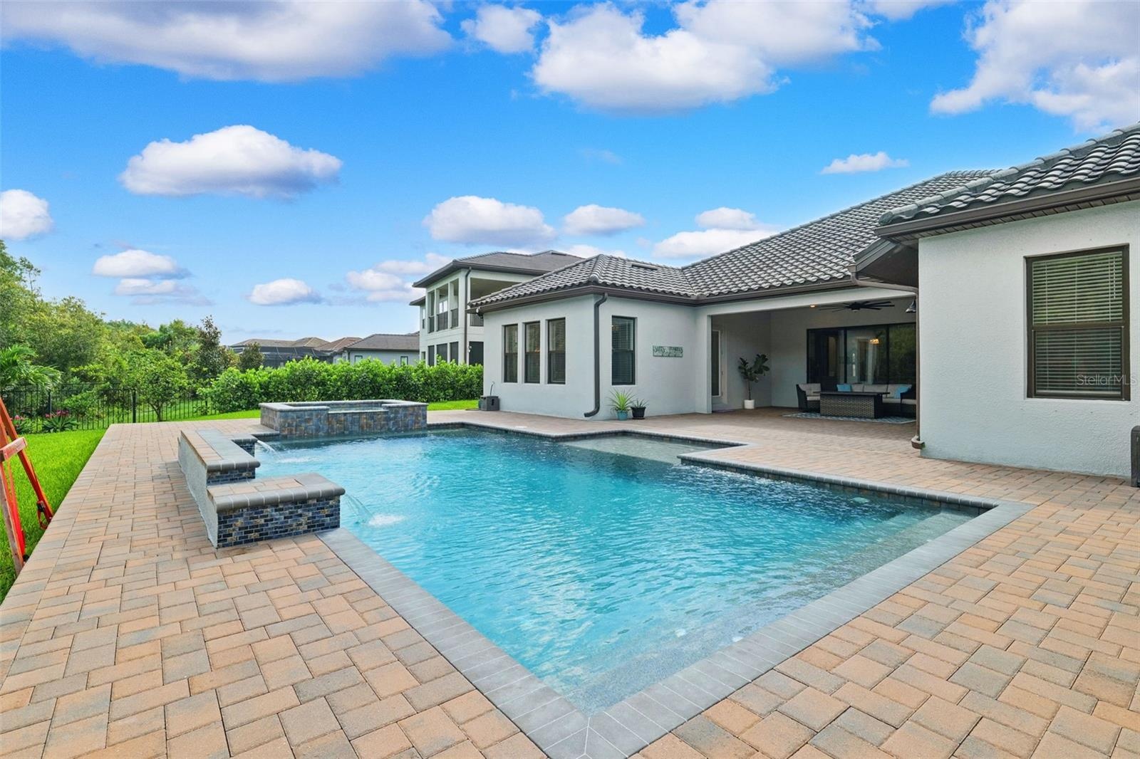 The backyard is the focal point of this property.  Oversized patio with a heated salt pool and built-in spa.