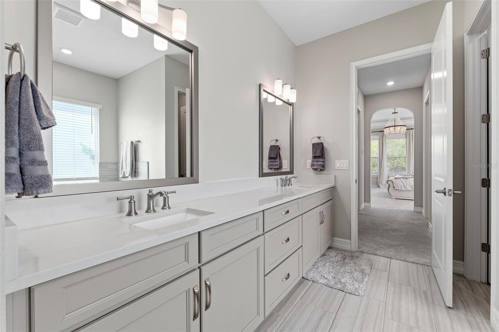 Dual sinks and oversized vanity along with a separate and private water closet.