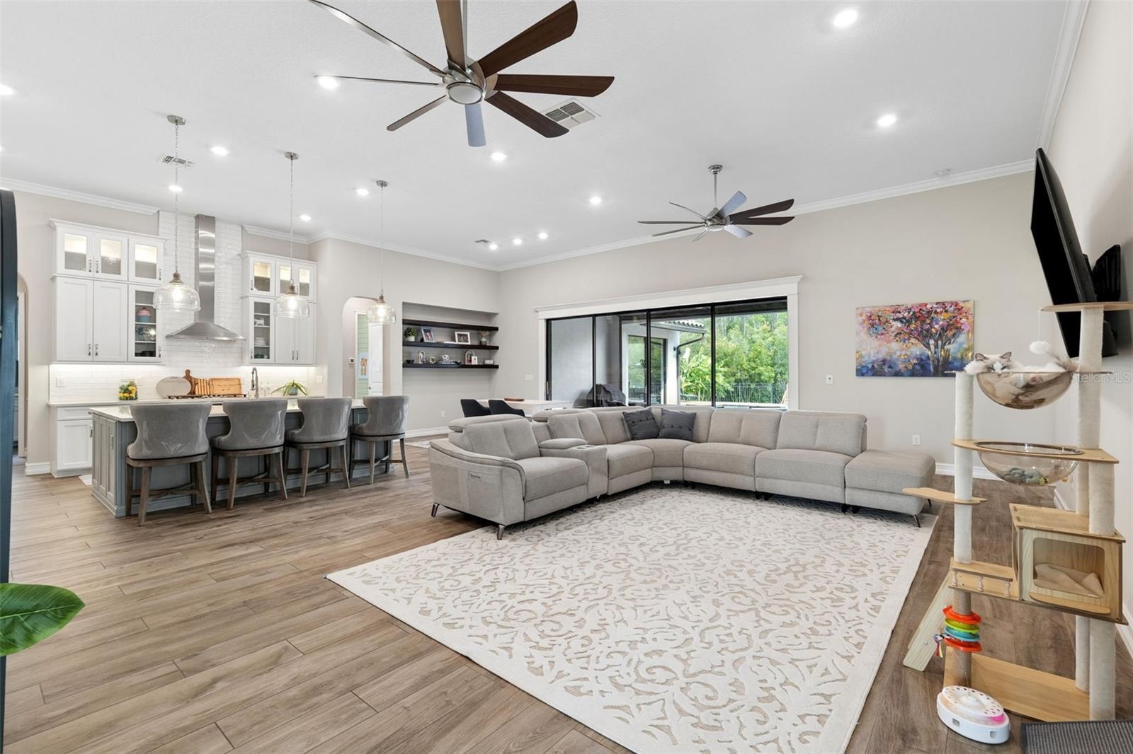 Spacious living room with dual oversized fans.