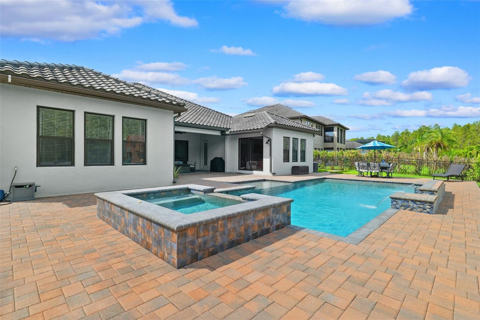 The backyard is the focal point of this property.  Oversized patio with a heated salt pool and built-in spa.