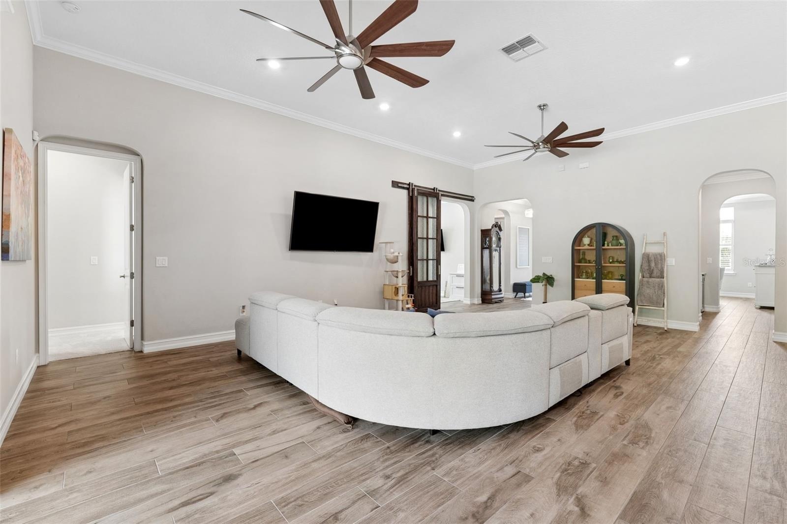 Spacious living room with dual oversized fans.