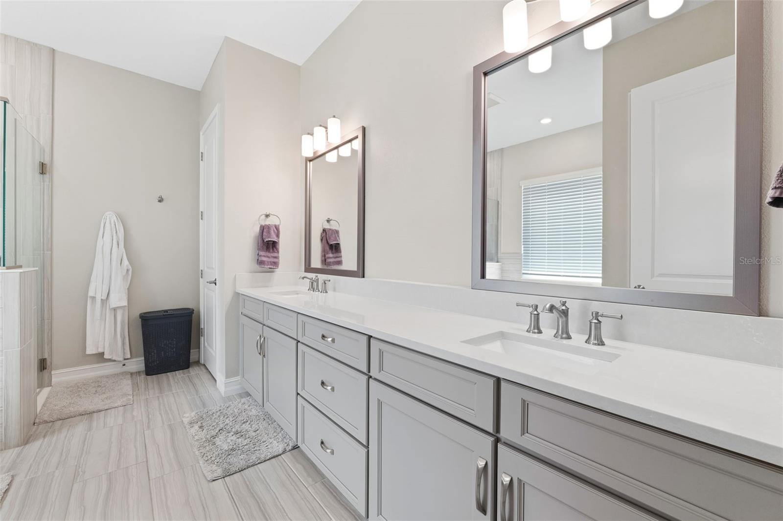 Dual sinks and oversized vanity along with a separate and private water closet.