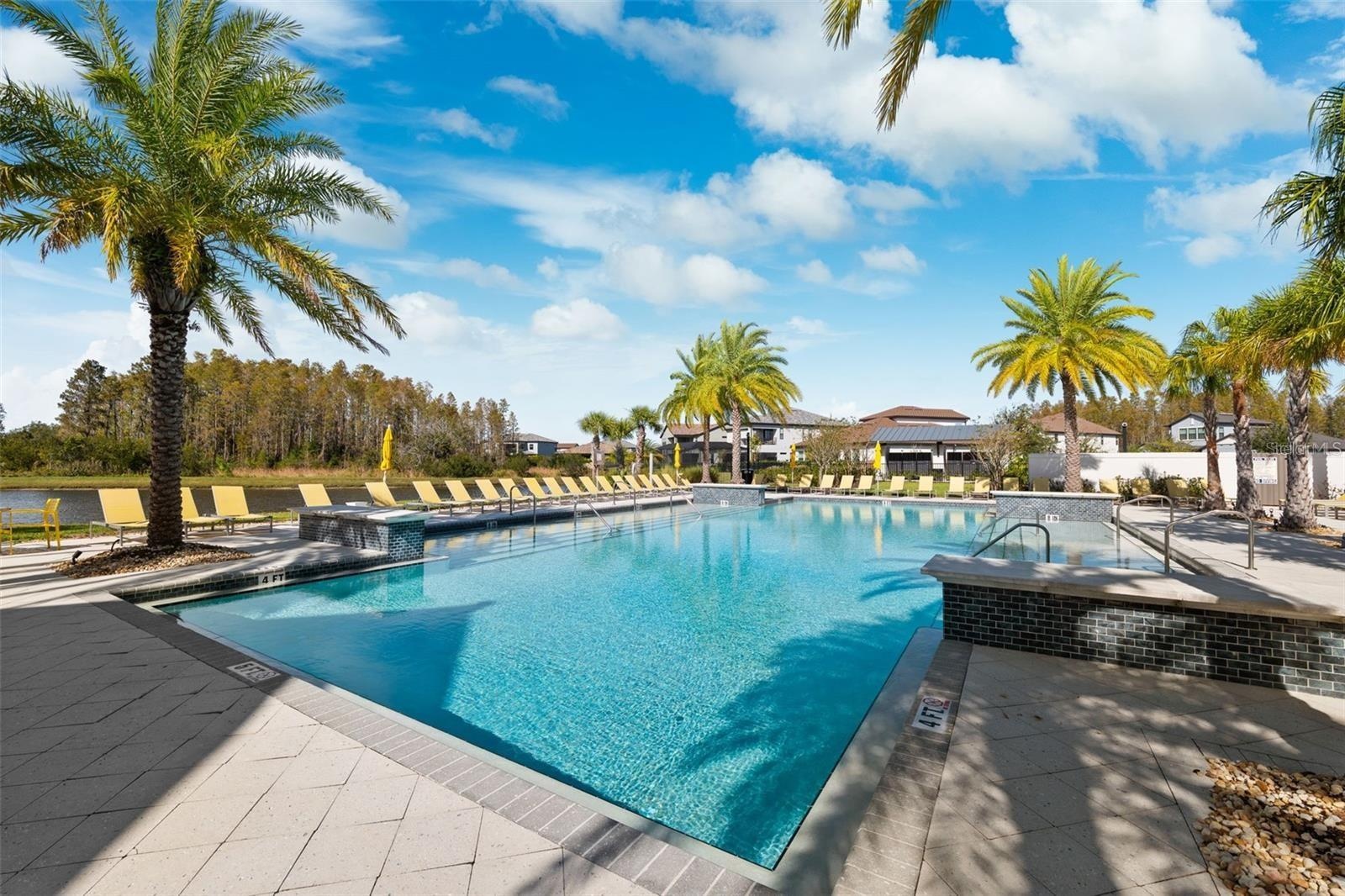 Resort style community clubhouse with a community pool, fitness center and lake front pool.