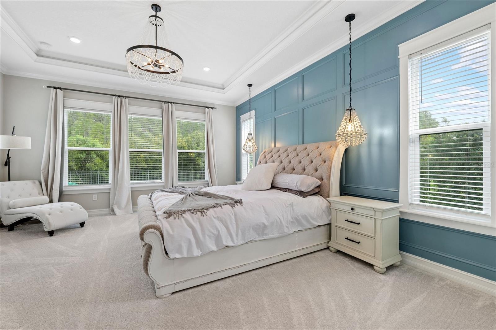 The primary bedroom is exquisite with tray ceilings and wall molding.