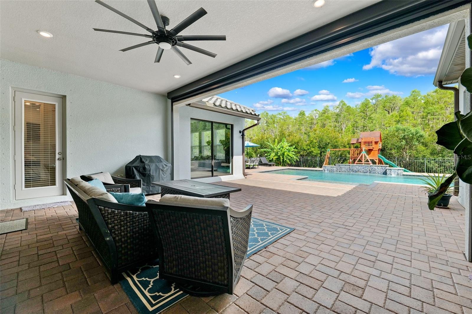 Covered patio offers protection from the Florida sun when needed and includes a hurricane rolldown shutter.