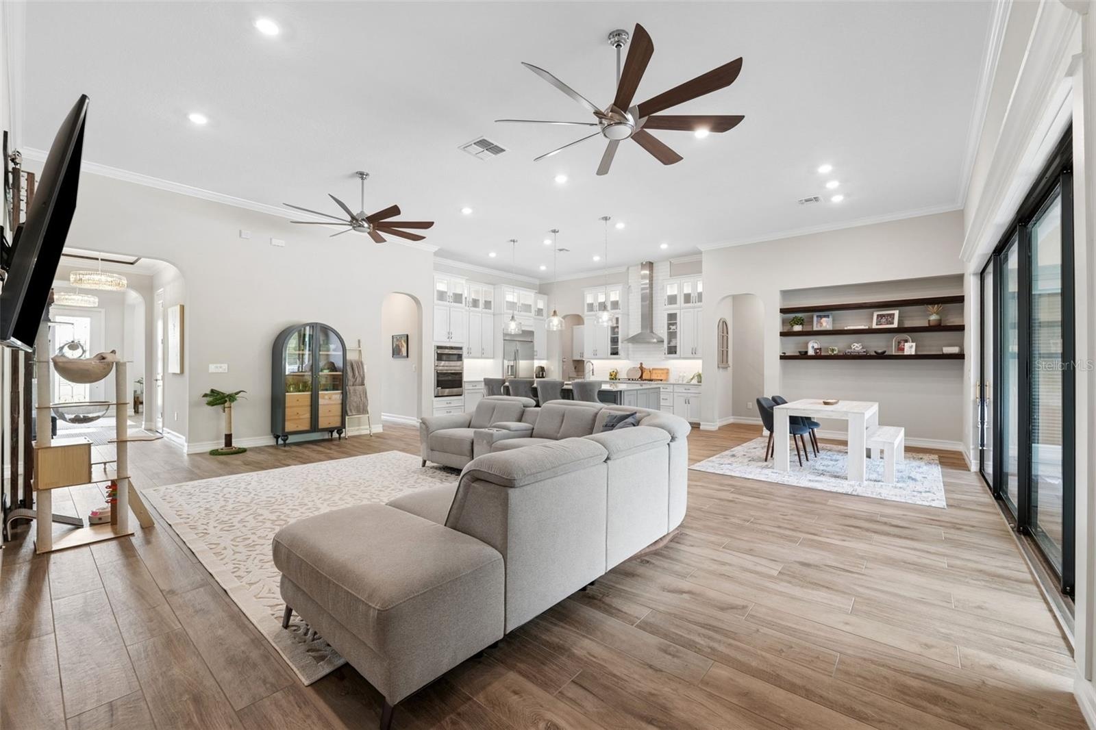 Spacious living room with dual oversized fans.