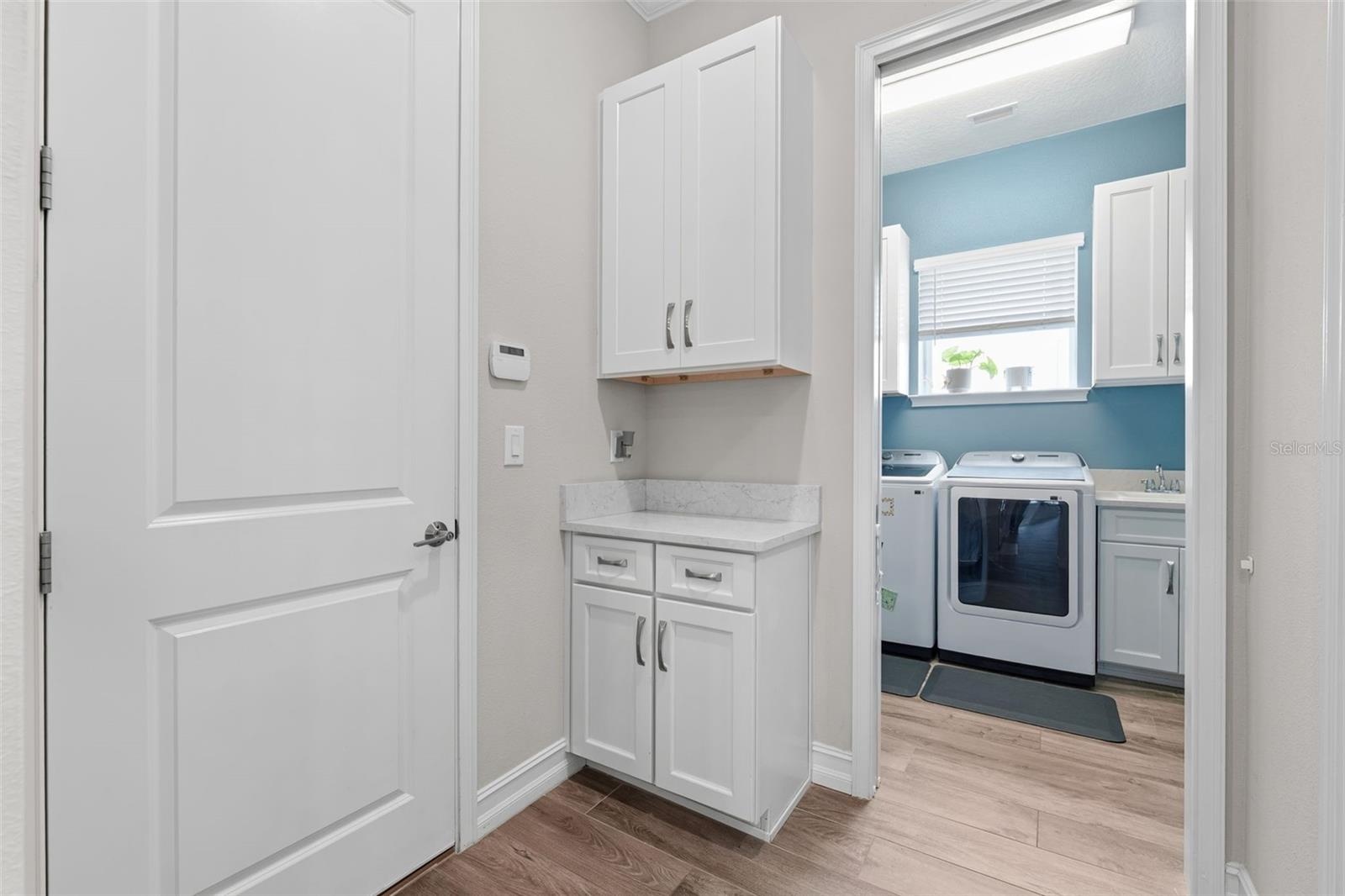 Garage entrance opens into the laundry room and a pantry closet that is located directly behind the kitchen.