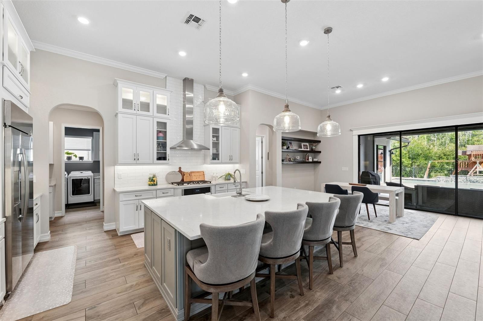 Oversized kitchen island provides space for entertaining guests and dining.