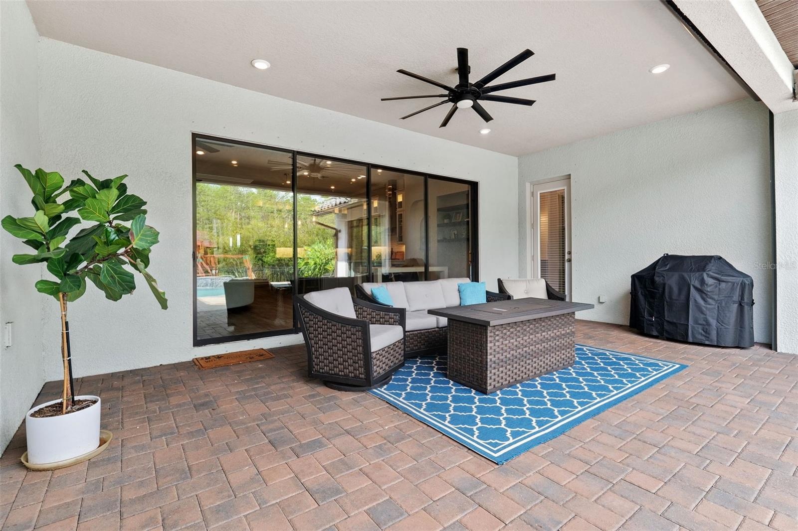 Covered patio offers protection from the Florida sun when needed and includes a hurricane rolldown shutter.