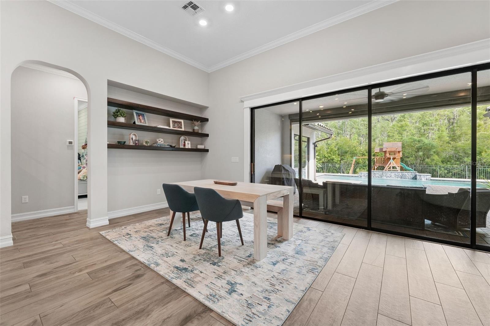 Second dining area is located off of the patio with pool and preserve views.