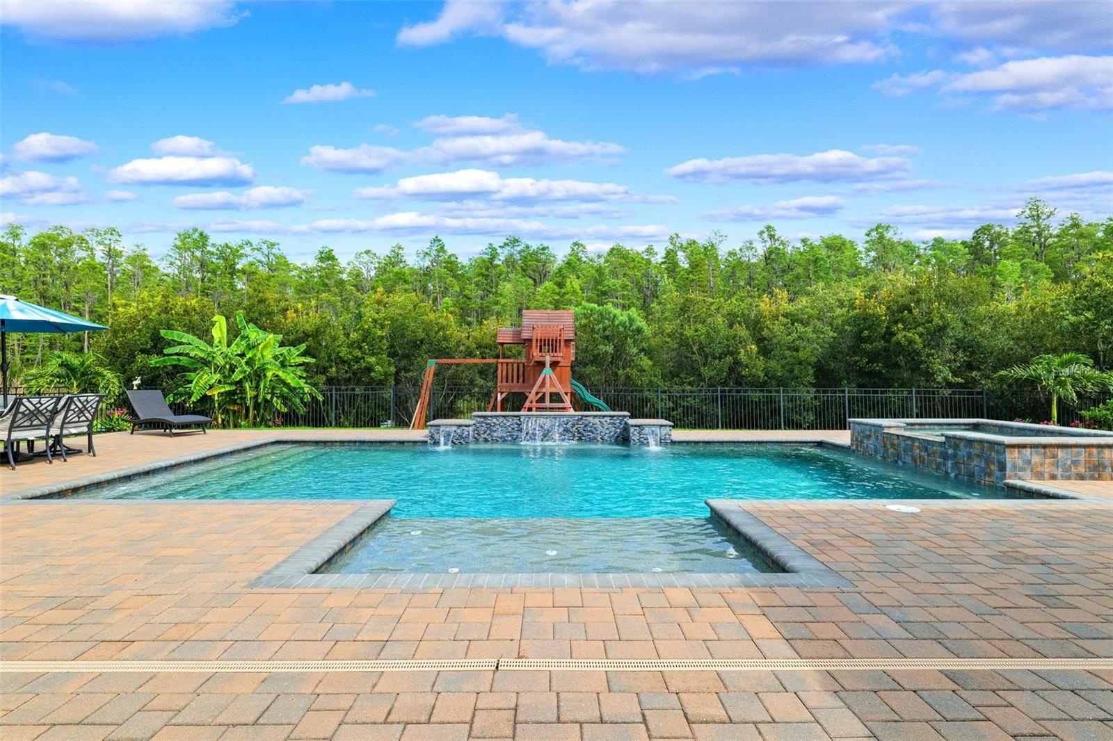 The backyard is the focal point of this property.  Oversized patio with a heated salt pool and built-in spa.