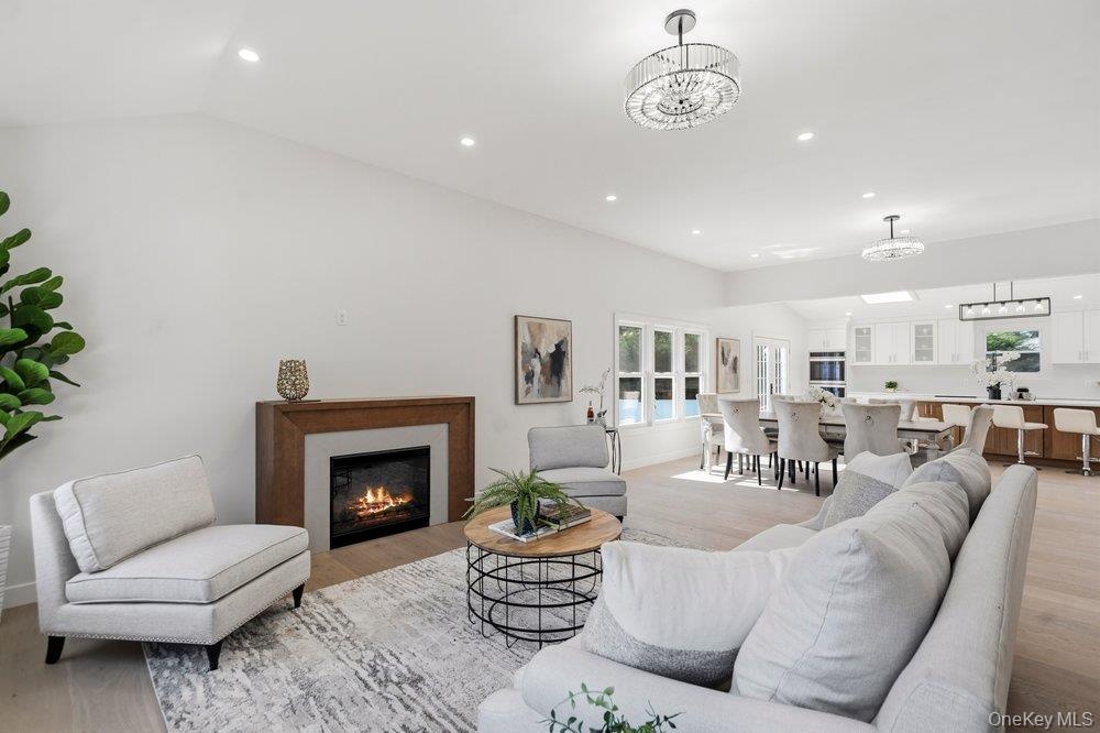 Open-concept Home with Vaulted Ceilings,  7 inch Wide Plank Natural Wood European White Oak Floor  In The Main Living areas.