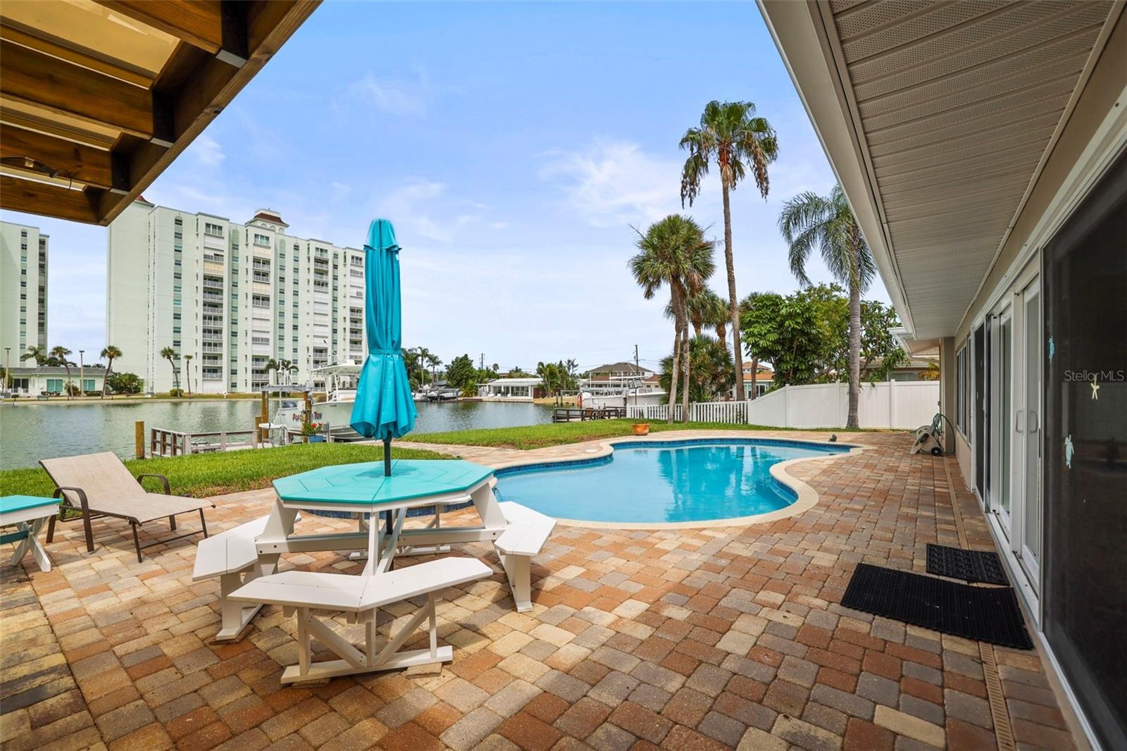Pool with patio seating and lounge area from the covered patio.