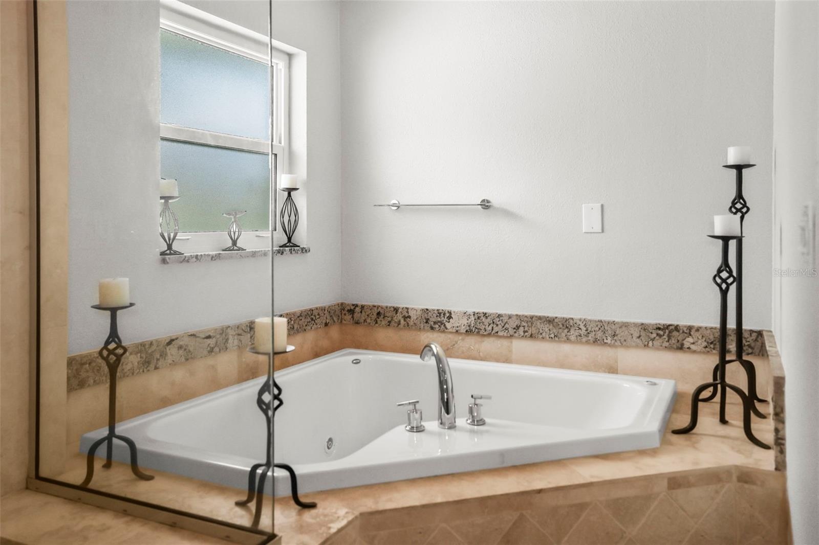Primary bathroom large corner tub.