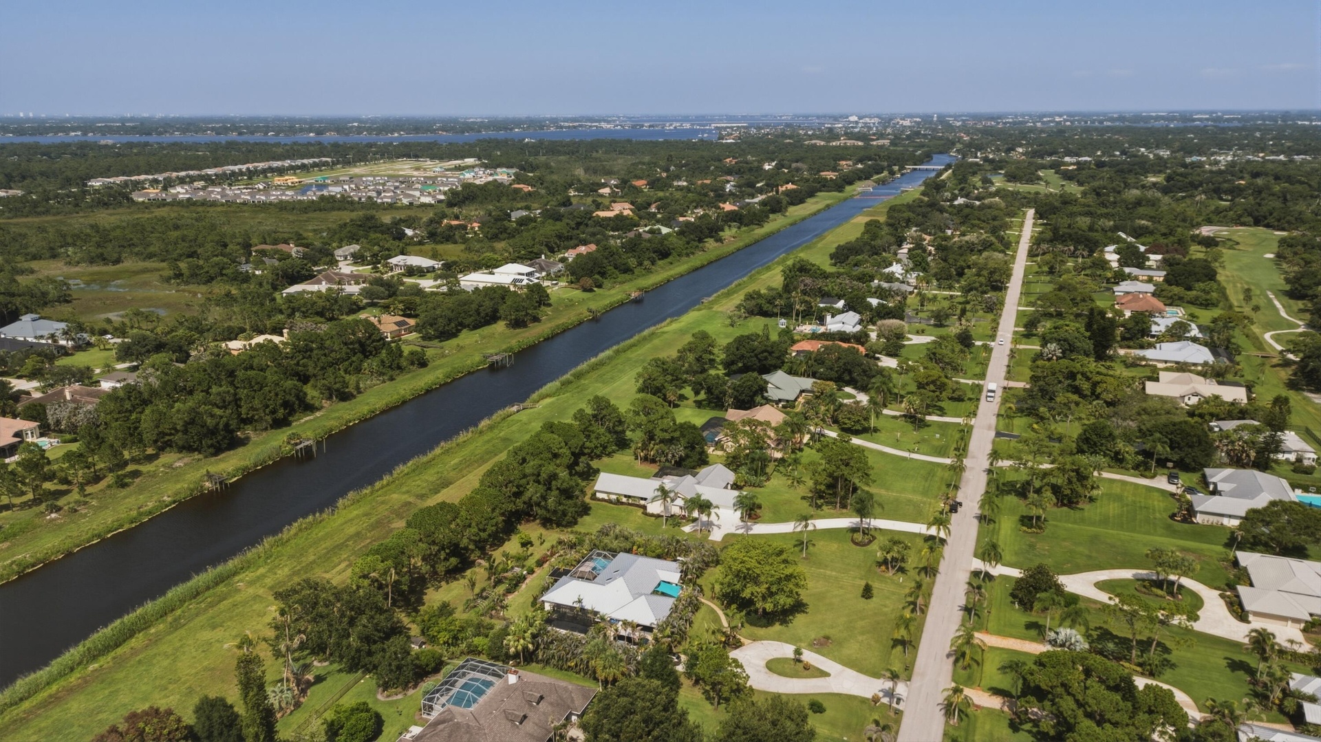 Expansive aerial perspective showcasing a waterway bordered by residential properties
