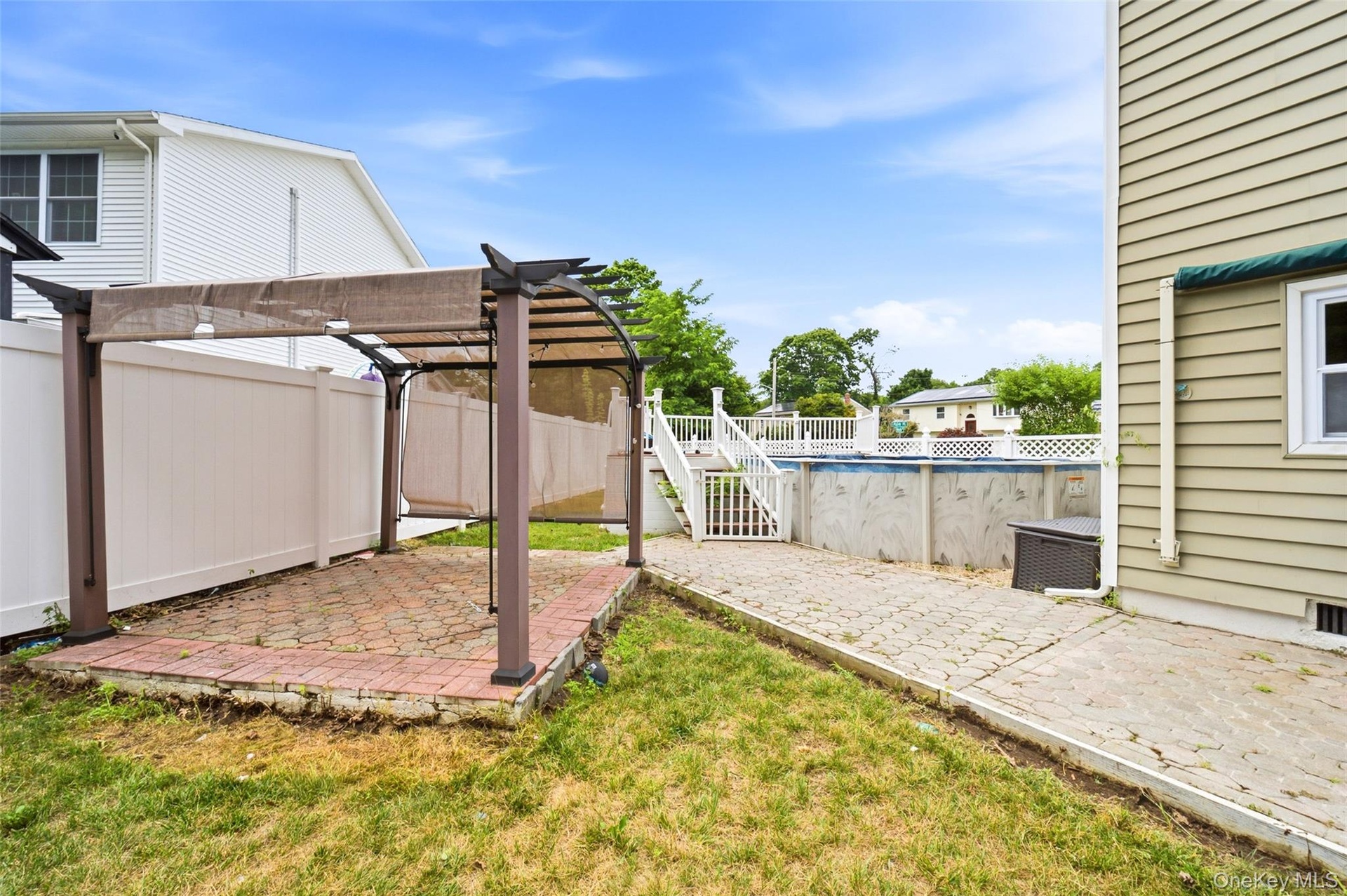 Perfect for relaxing in your Outdoor living area featuring a pergola with a fabric canopy, a paver patio, and a privacy fence