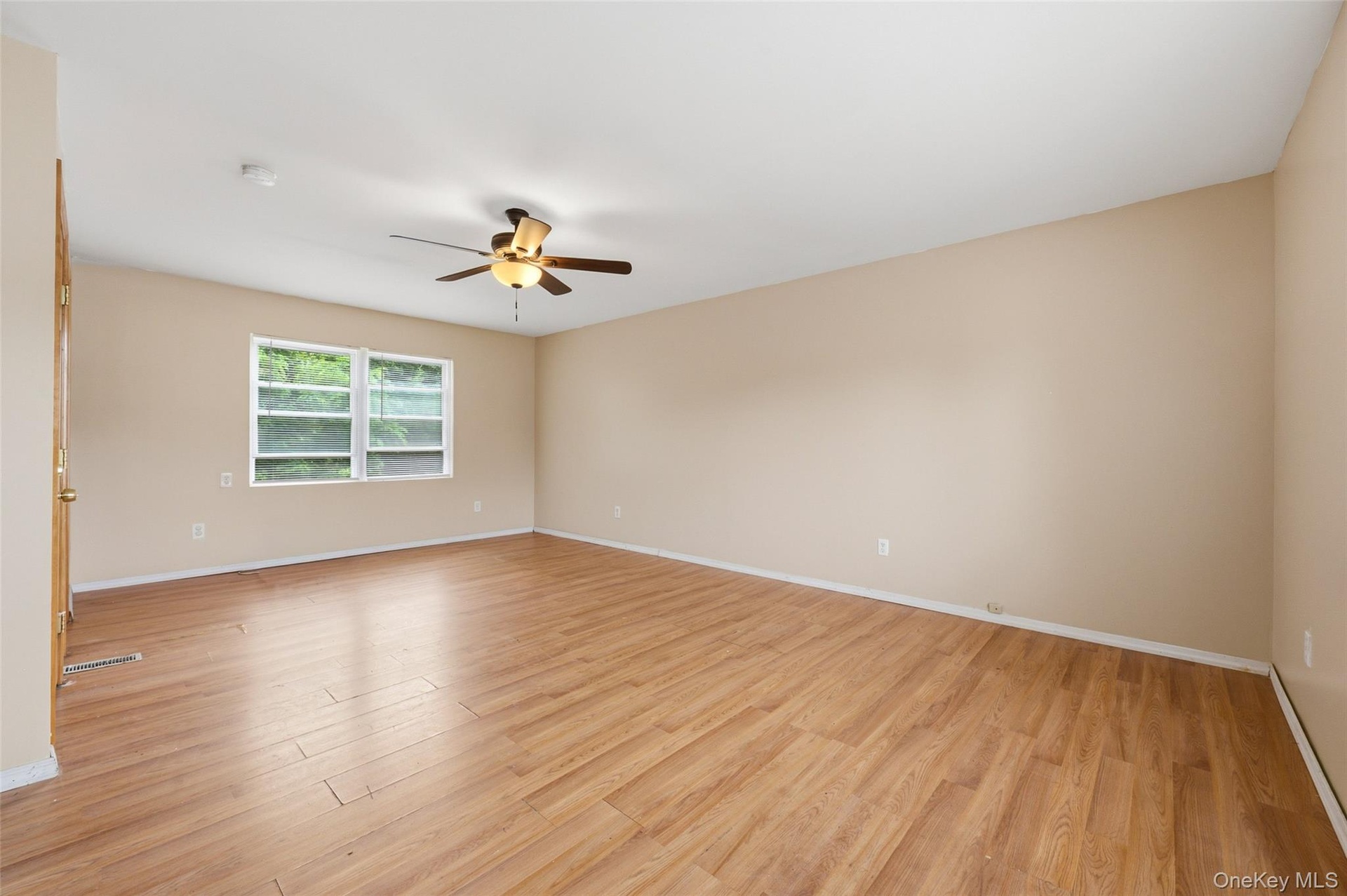 Freshly Painted Primary Bedroom suite with the window that faces the private backyard.
