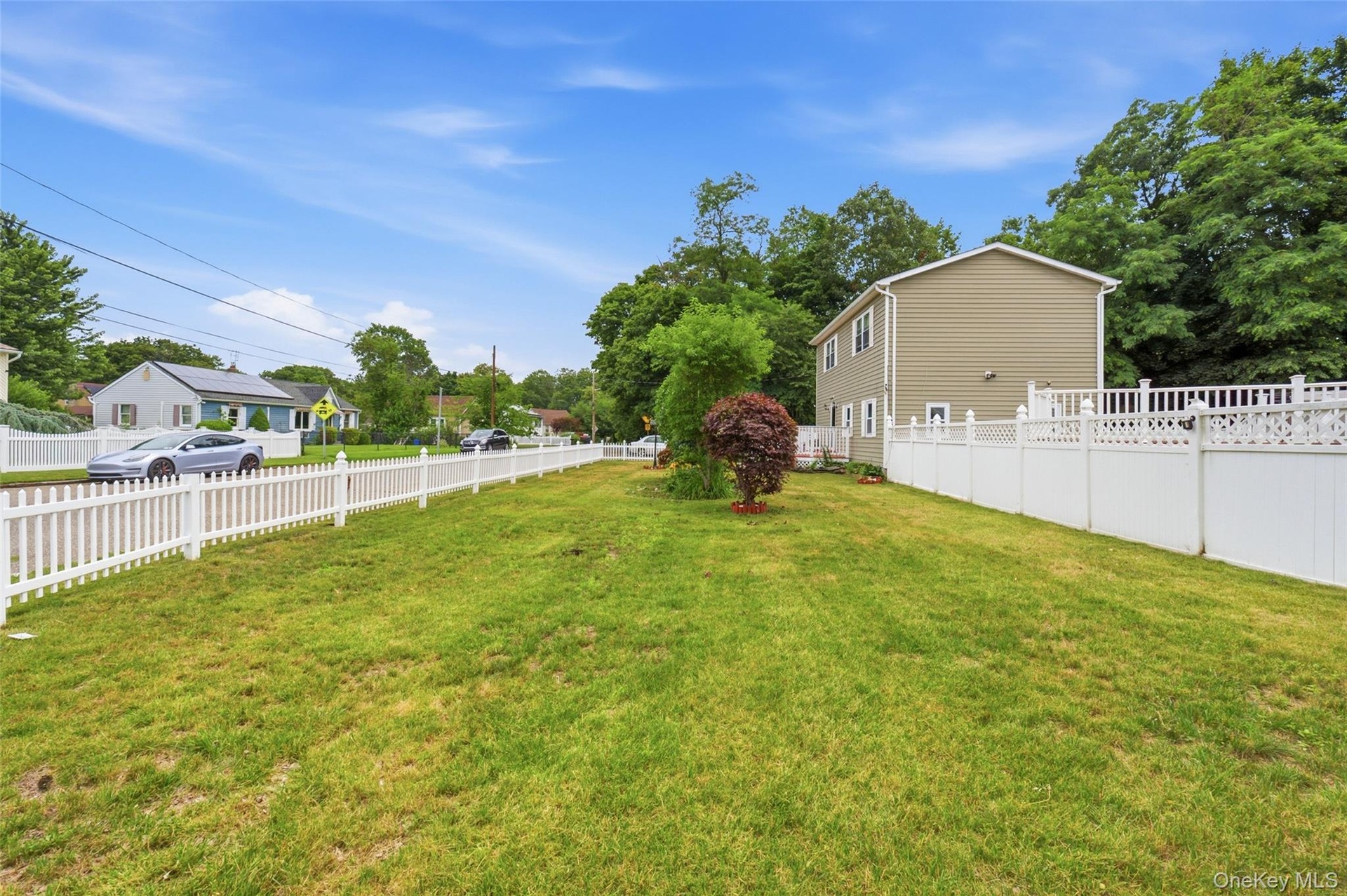 Front yard with a white picket fence.  Corner Property.  Call to view this home