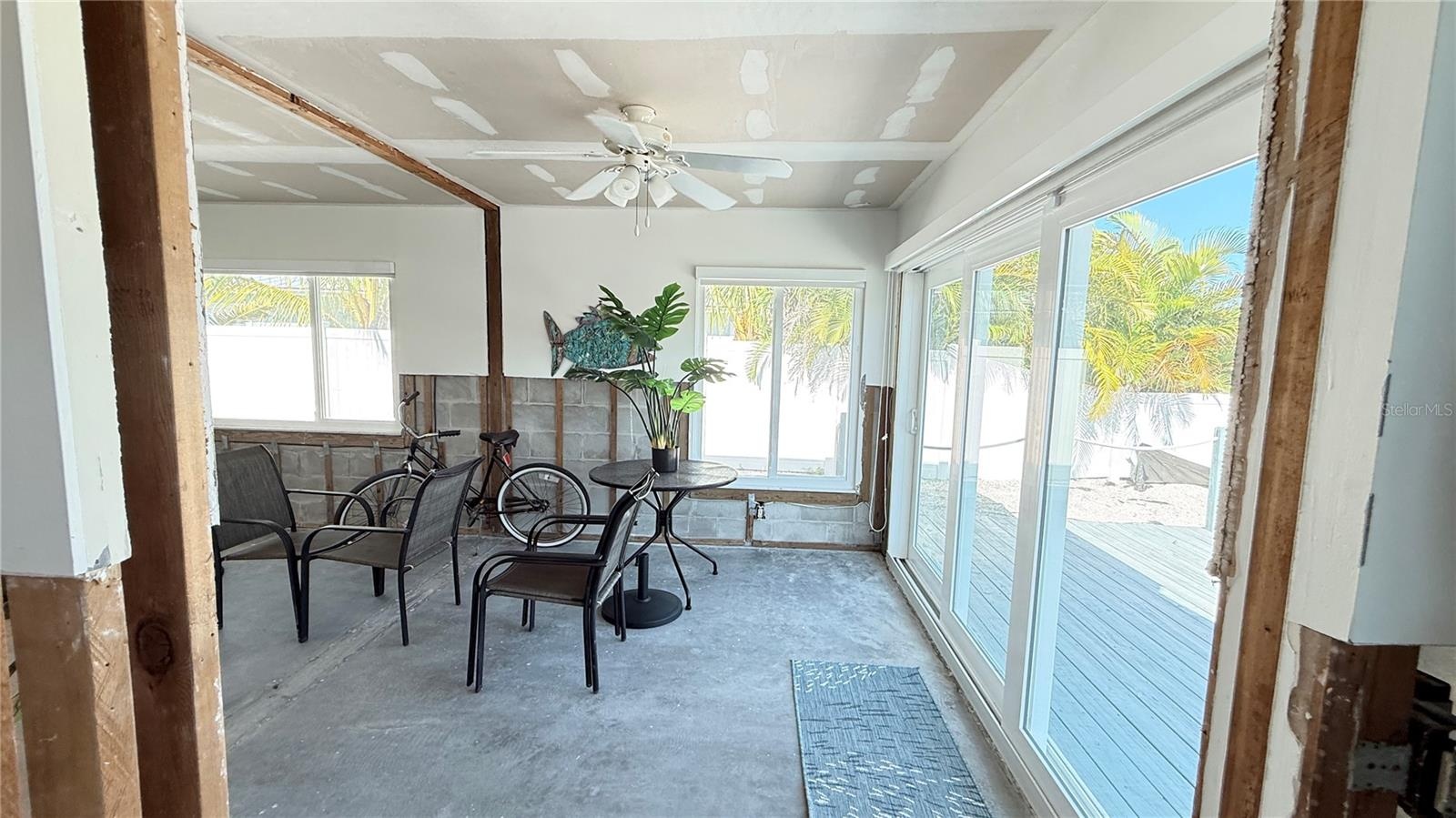 Sliding doors that lead to the wooden deck and seawall.