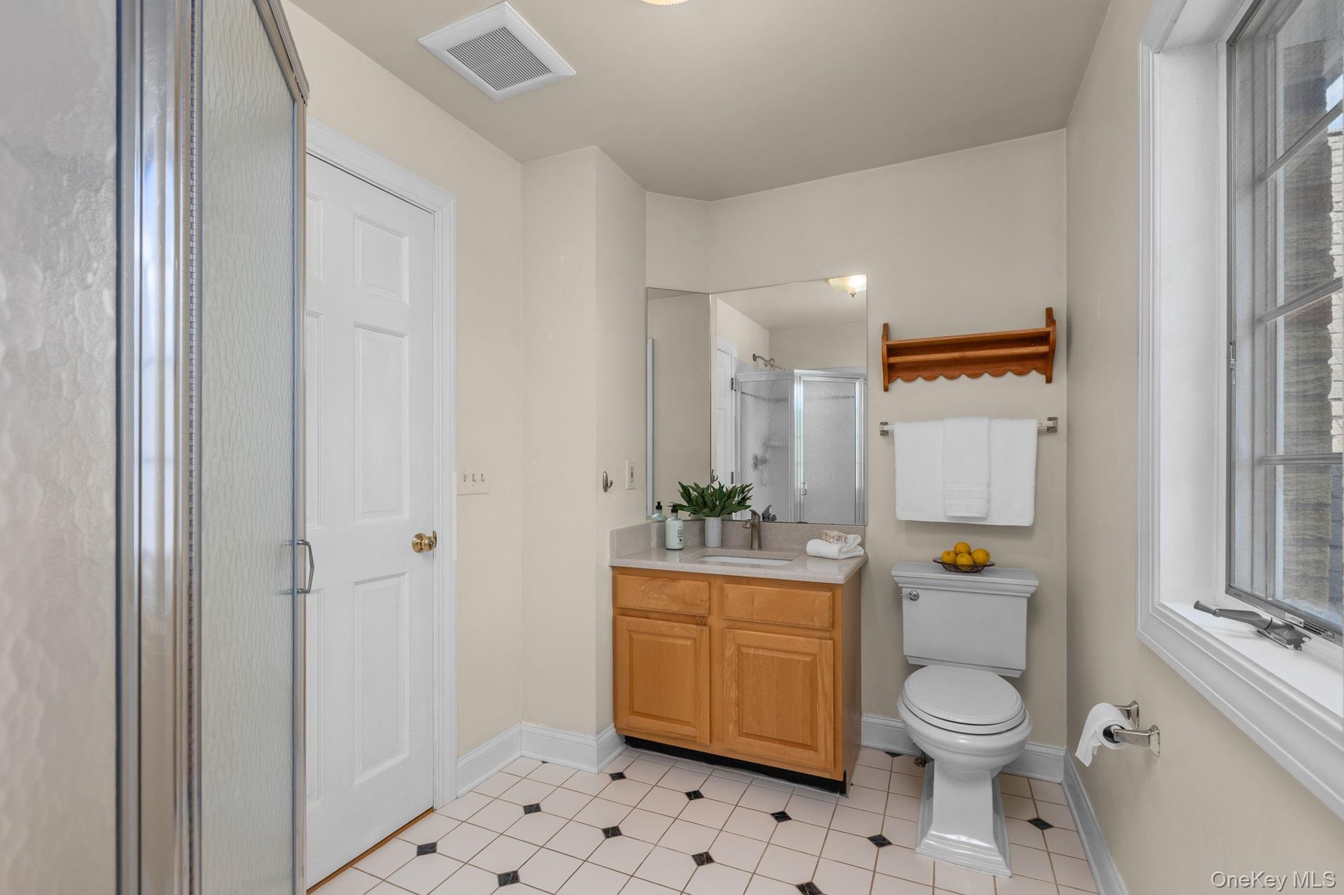 This thoughtfully positioned bathroom provides flexibility with access from the bedroom and hall.