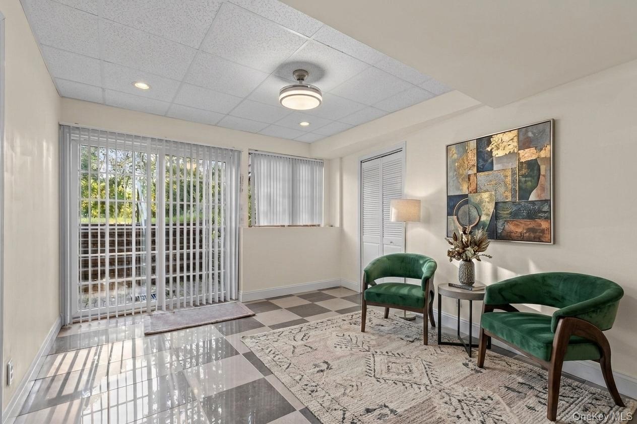 Located on the lower level, a charming sitting area welcomes you in from the backyard, creating a cozy transition between indoor and outdoor living.
