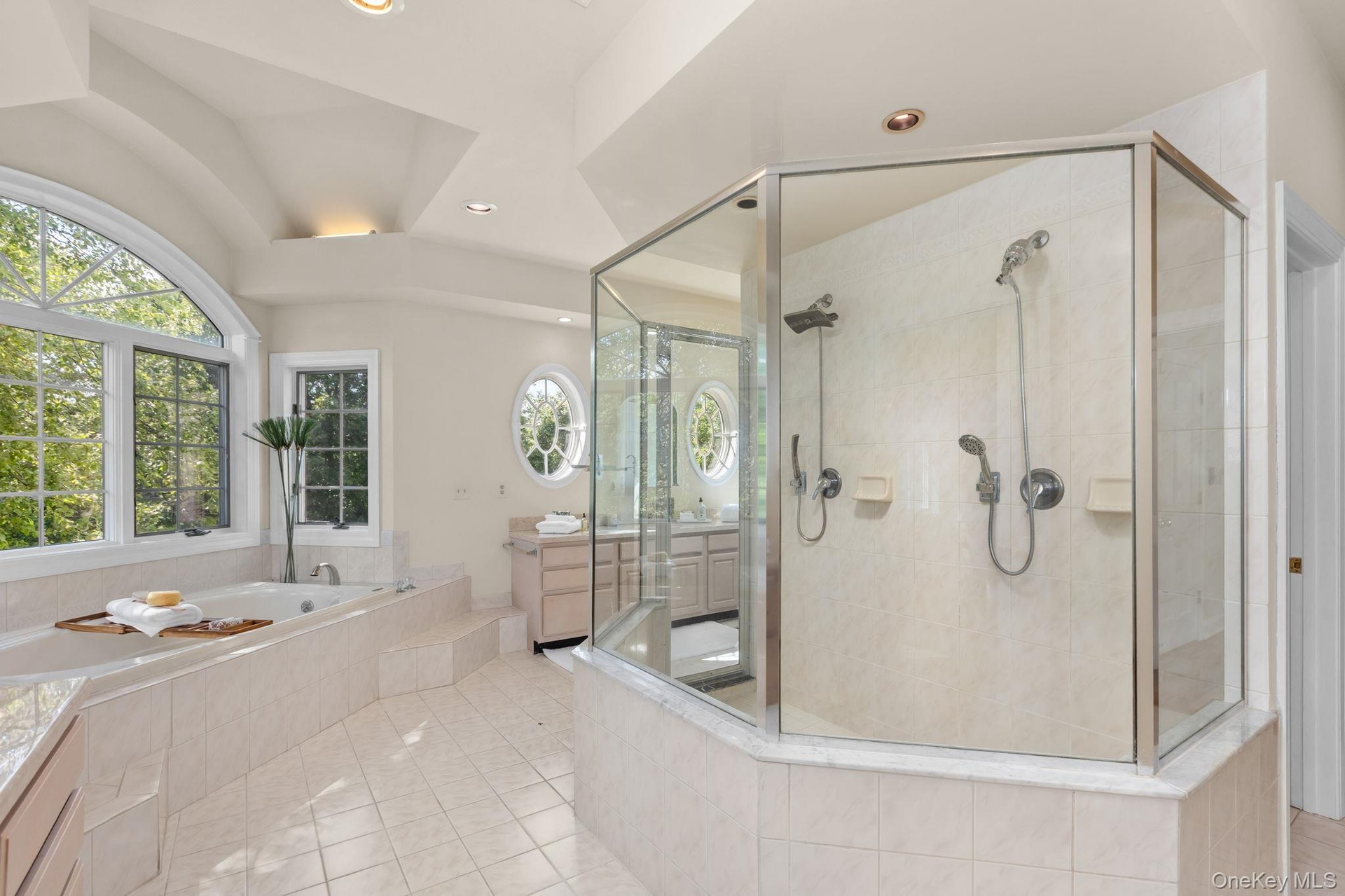Designed for modern luxury, this primary bathroom includes a spacious glass shower and beautifully appointed details.