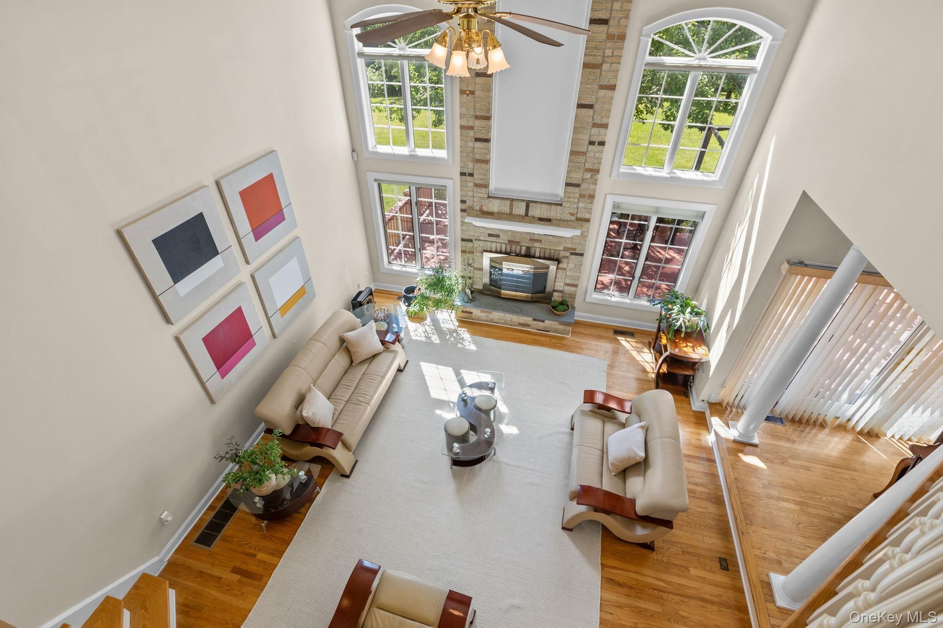 The upper-level balcony overlooks the expansive family room, enhancing the home's open, airy design.