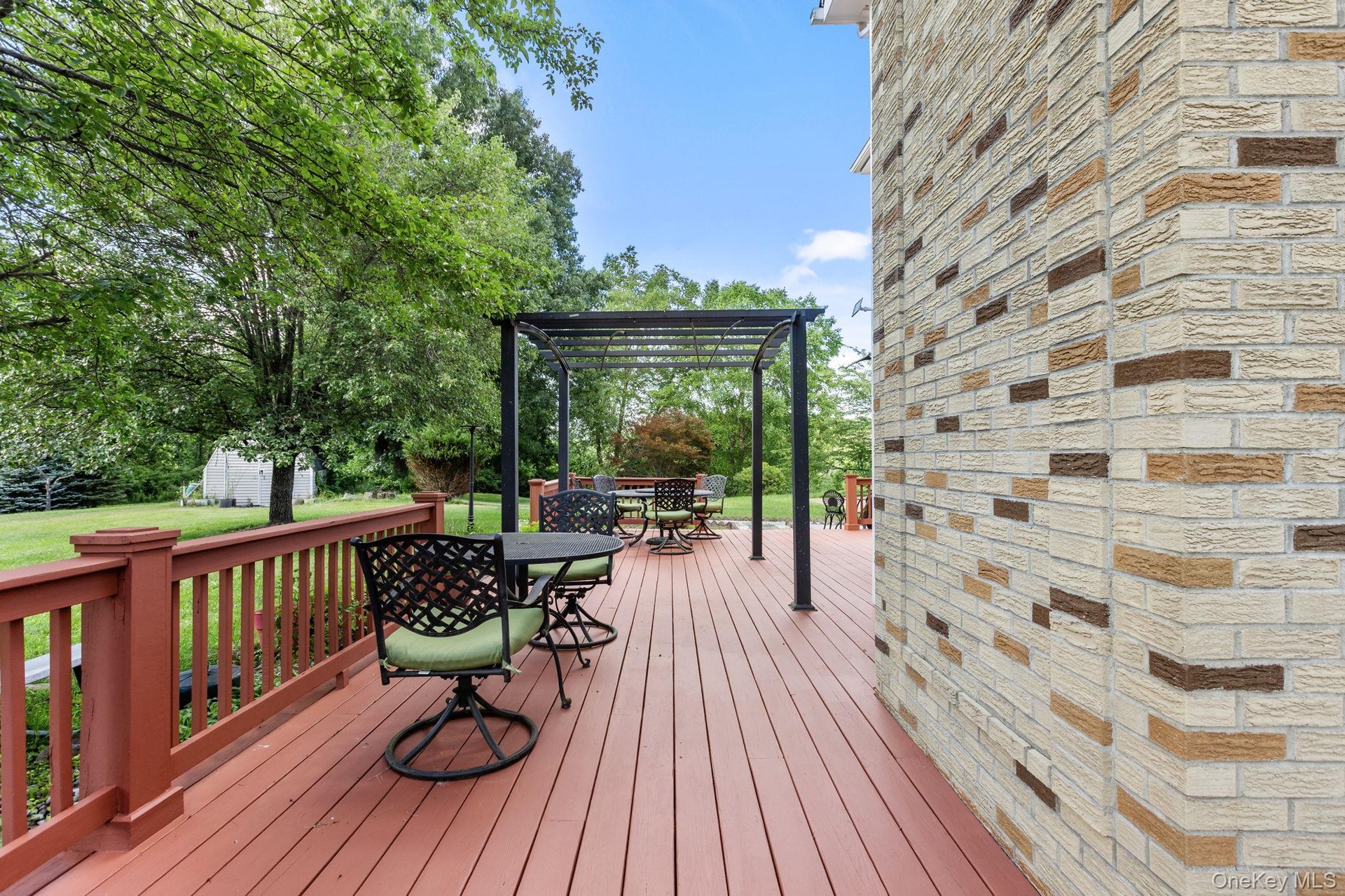 Freshly painted deck with a charming pergola, creating an inviting outdoor retreat for relaxing and entertaining.
