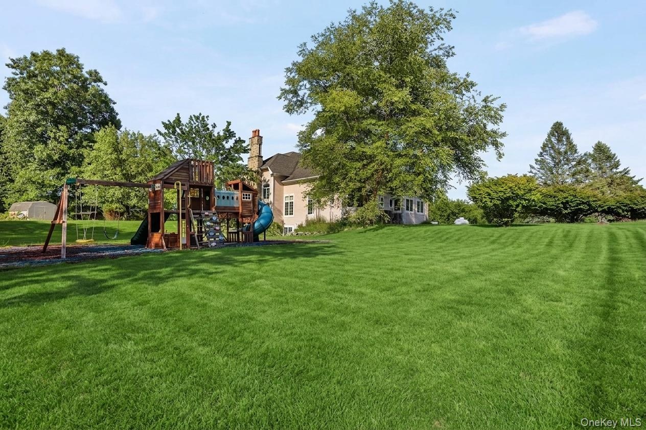 A generous level lawn with a dedicated play area enhances the property’s exceptional outdoor appeal.