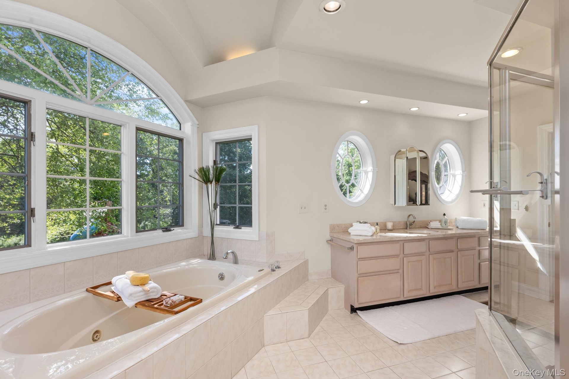Designed for relaxation, this sophisticated bathroom features two vanities and a tranquil soaking tub.