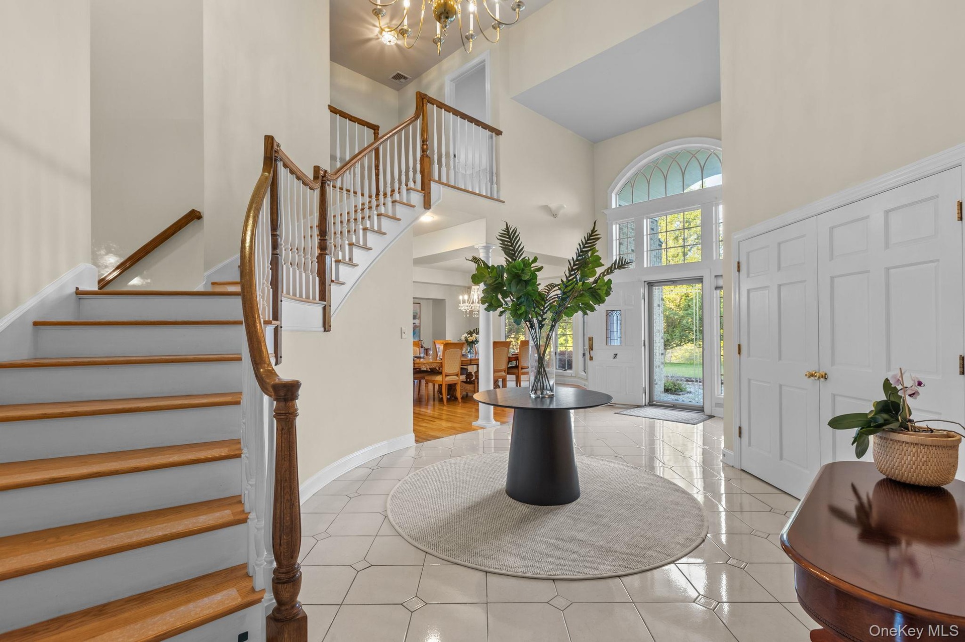 An elegant grand foyer filled with natural light and classic architectural details.