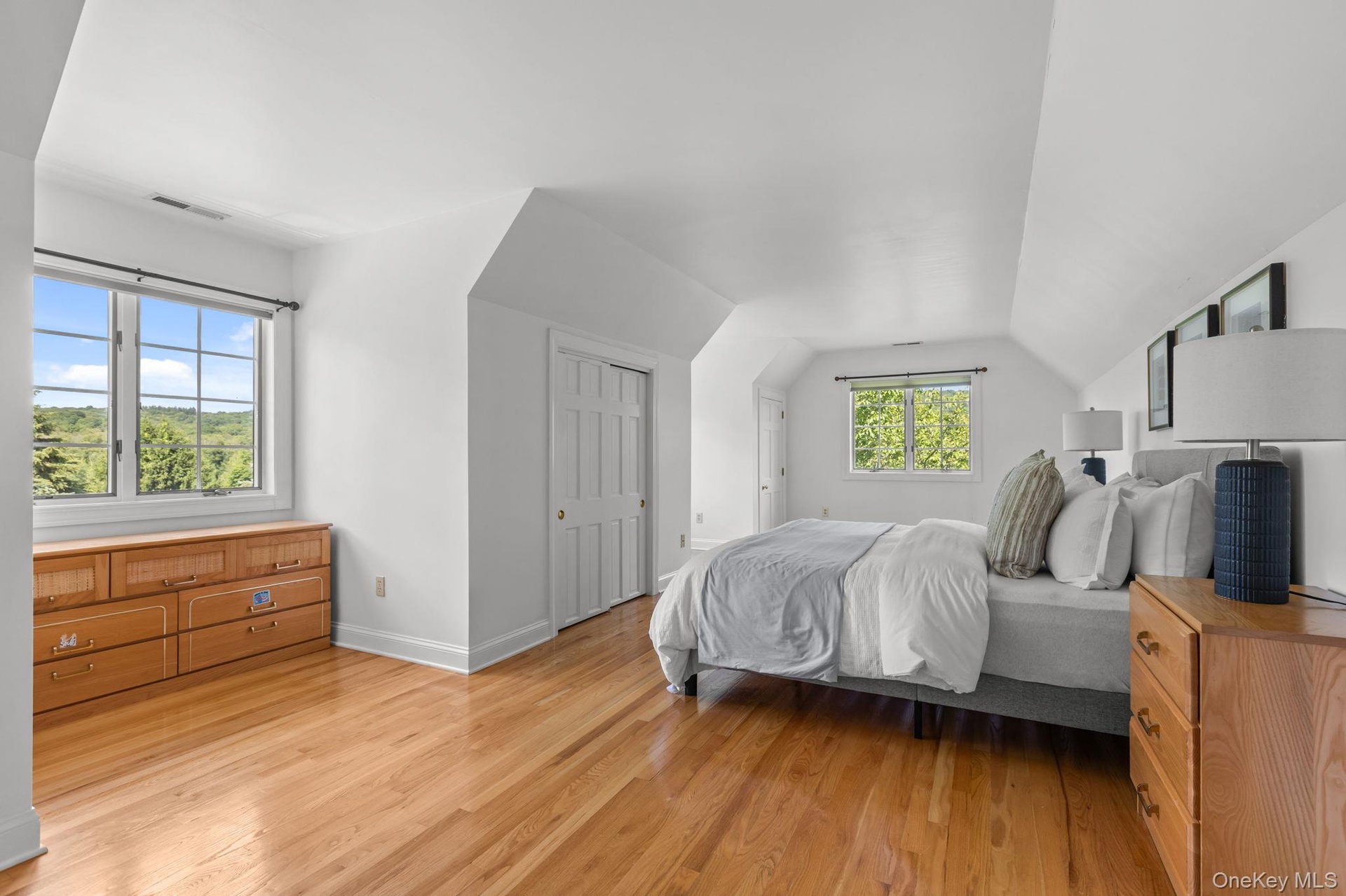An inviting bonus room featuring high ceilings, ample closet space, and warm hardwood flooring. Although staged as a bedroom it is considered addition