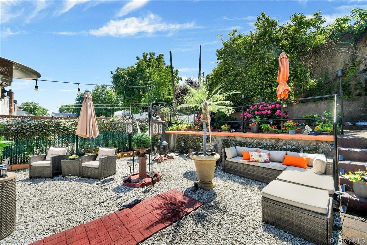 Expansive outdoor patio featuring gravel surfacing and a brick-patterned walkway