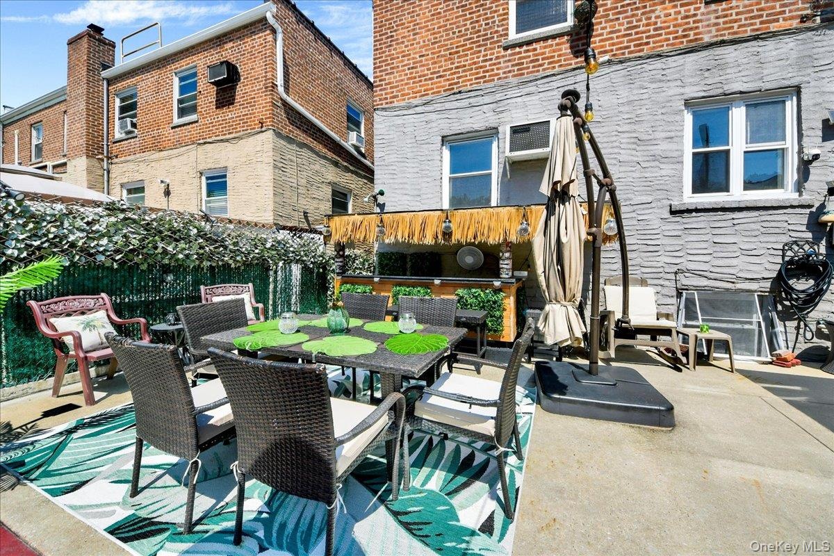 Outdoor patio space featuring a built-in bar, and privacy screening