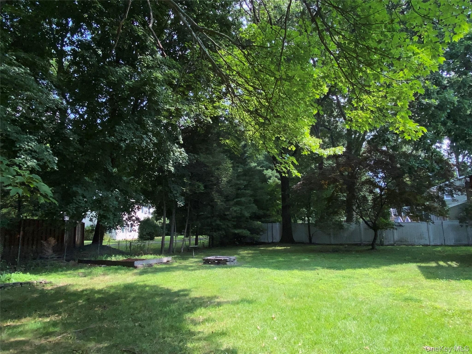Spacious wide open private flat backyard with wooden swing and room for a pool or possibly even a pickleball court