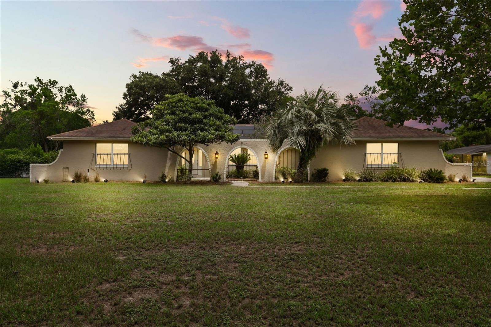 Nestled on an OVERSIZED HOMESITE of well over half an acre in the sought-after Lake Ann Estates of Winter Park.