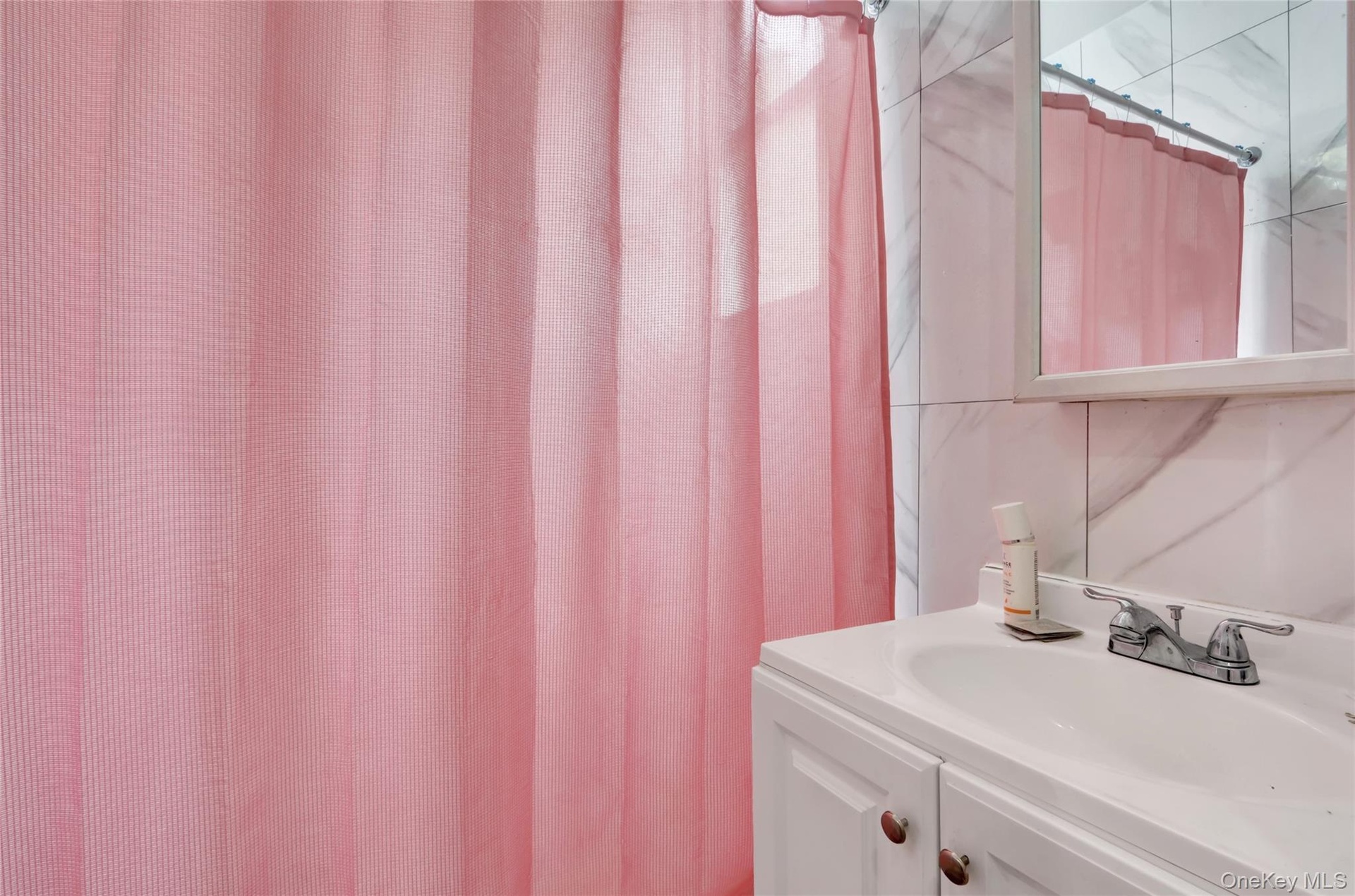 White vanity with an integrated sink and chrome faucet