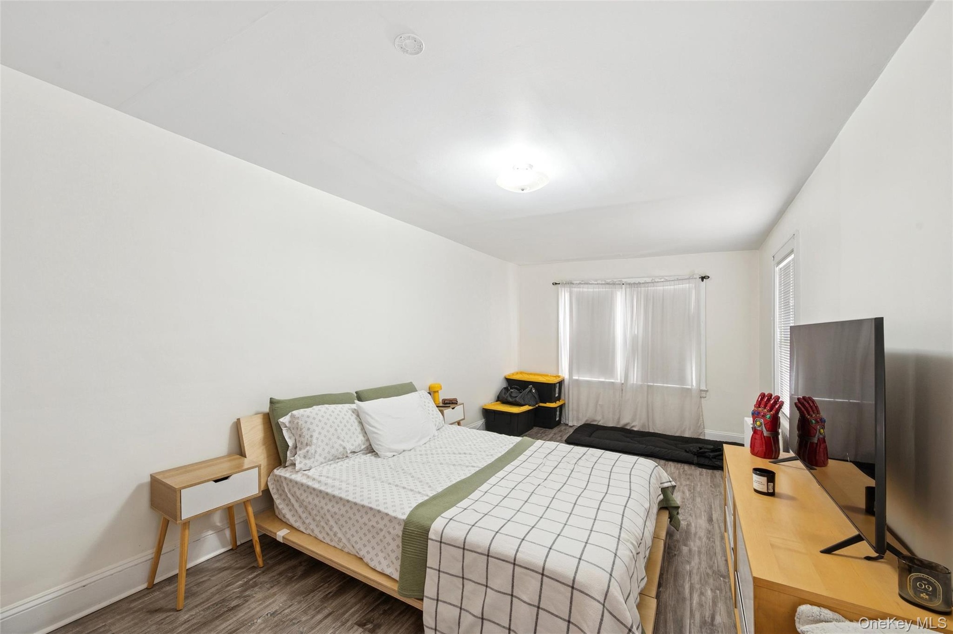 Bedroom with wood finished floors and baseboards