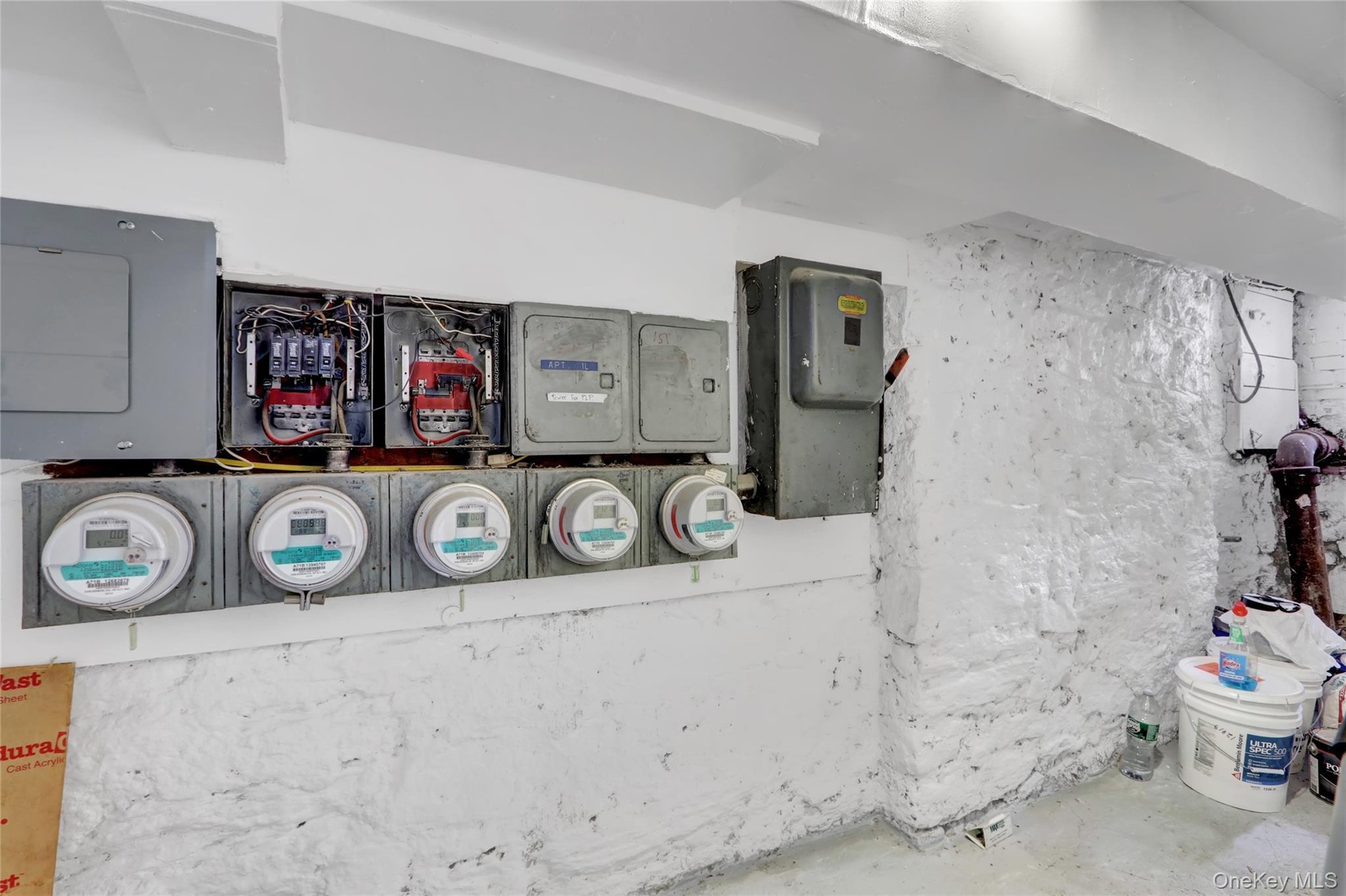 Electrical panels and utility meters installed on a painted stone wall