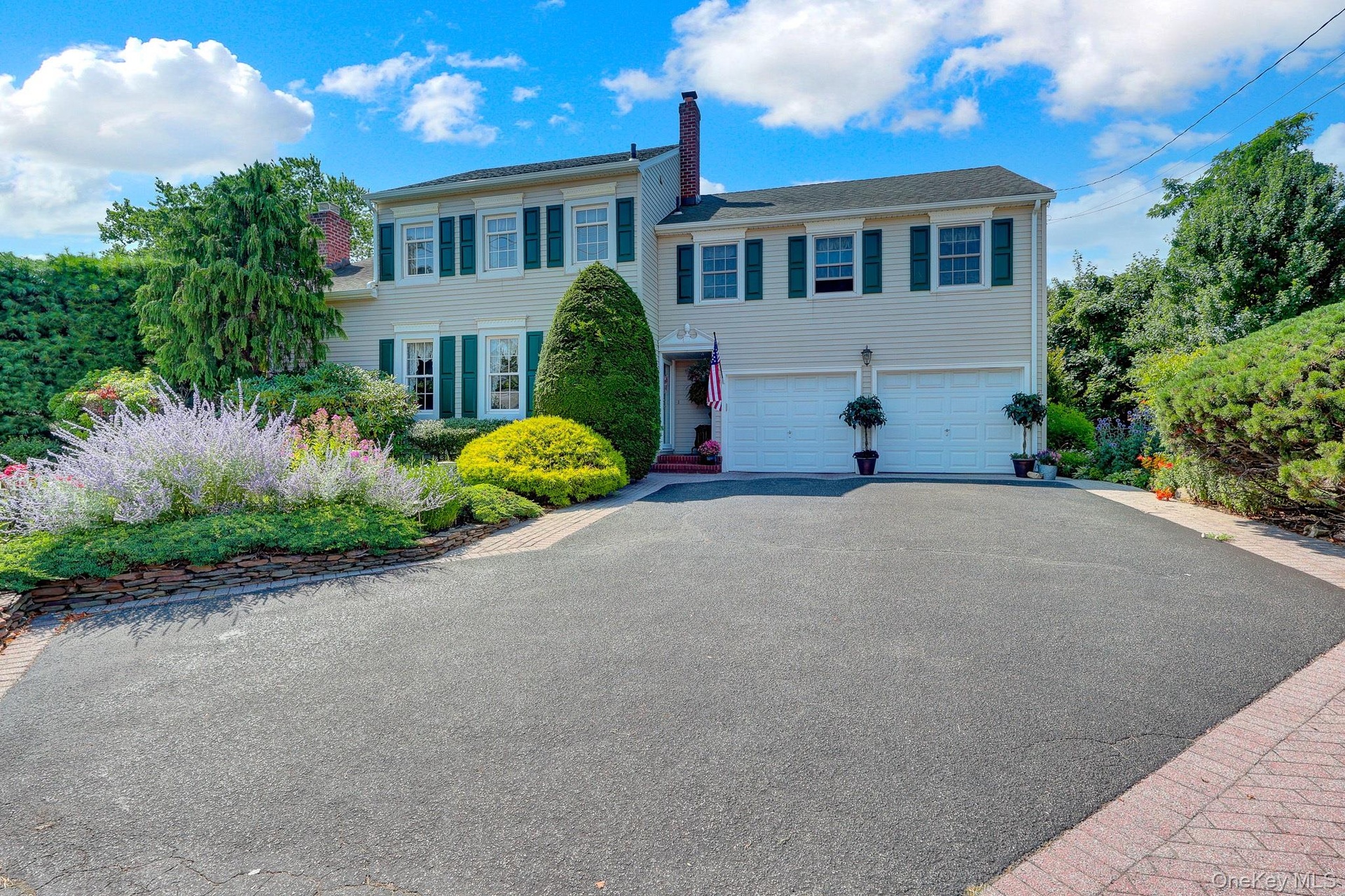 Extra-wide driveway with attached oversized 2 car garage.