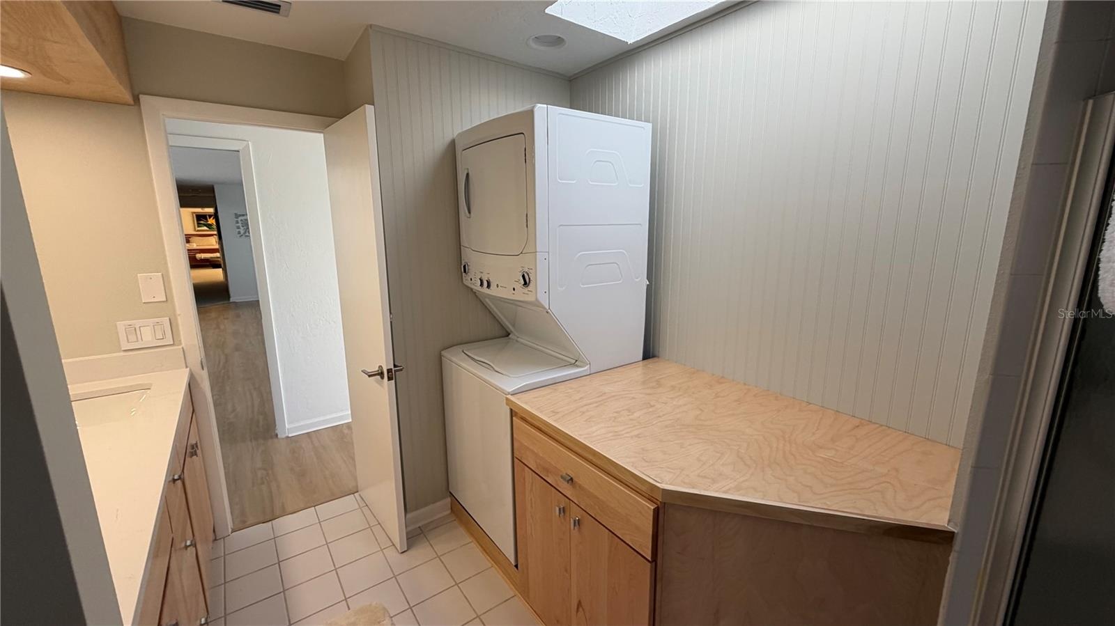 Shared guest bathroom also serves as a laundry room.