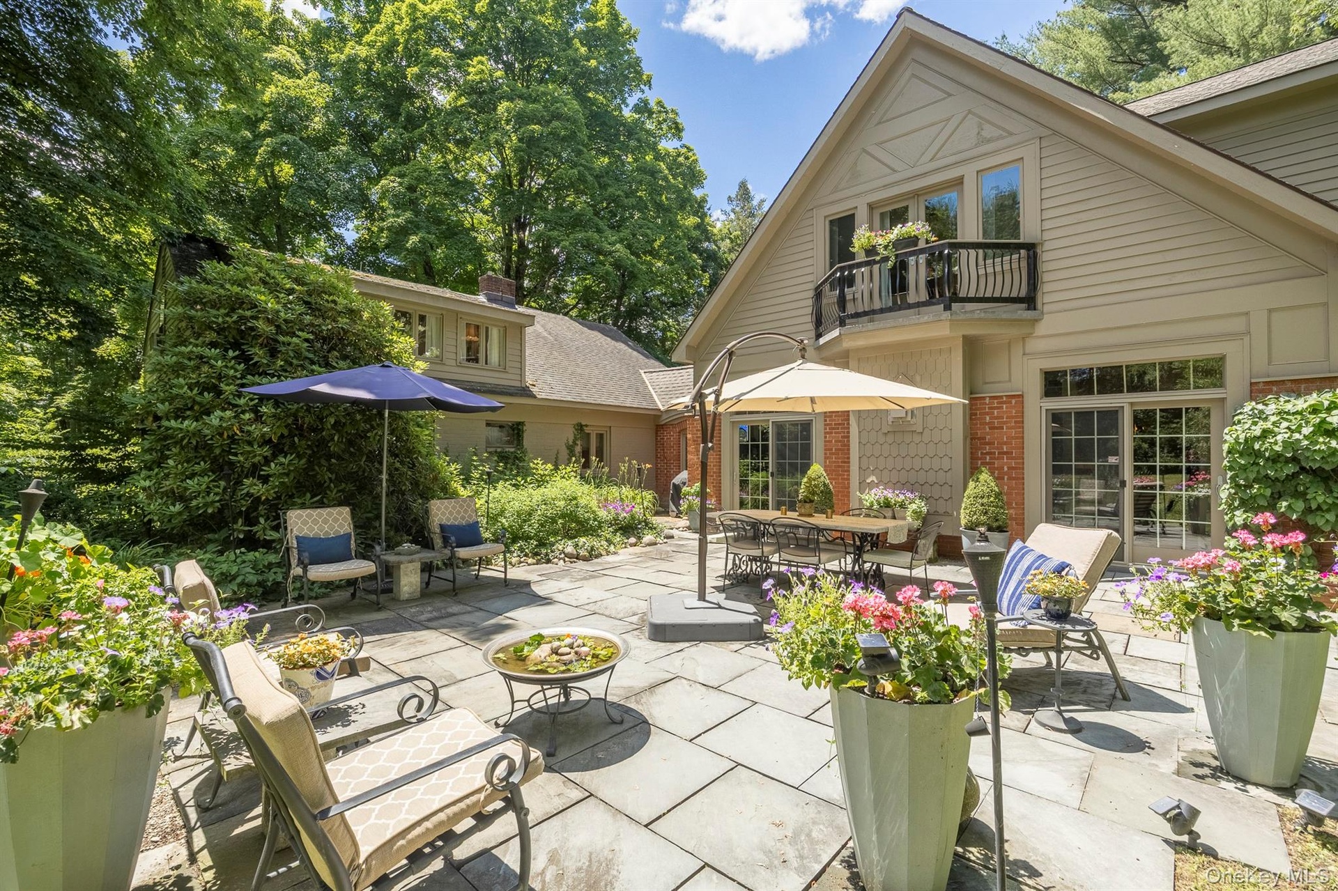 A large 650 sq ft stone patio is one of multiple outdoor entertainment areas
