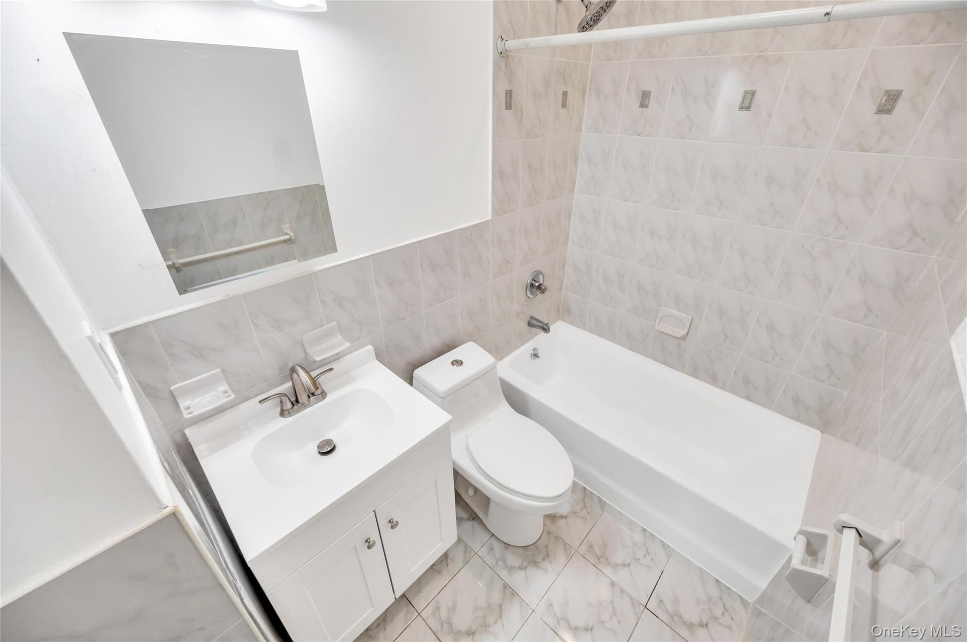 Bathroom featuring a white vanity with a basin sink, chrome faucet, and integrated storage