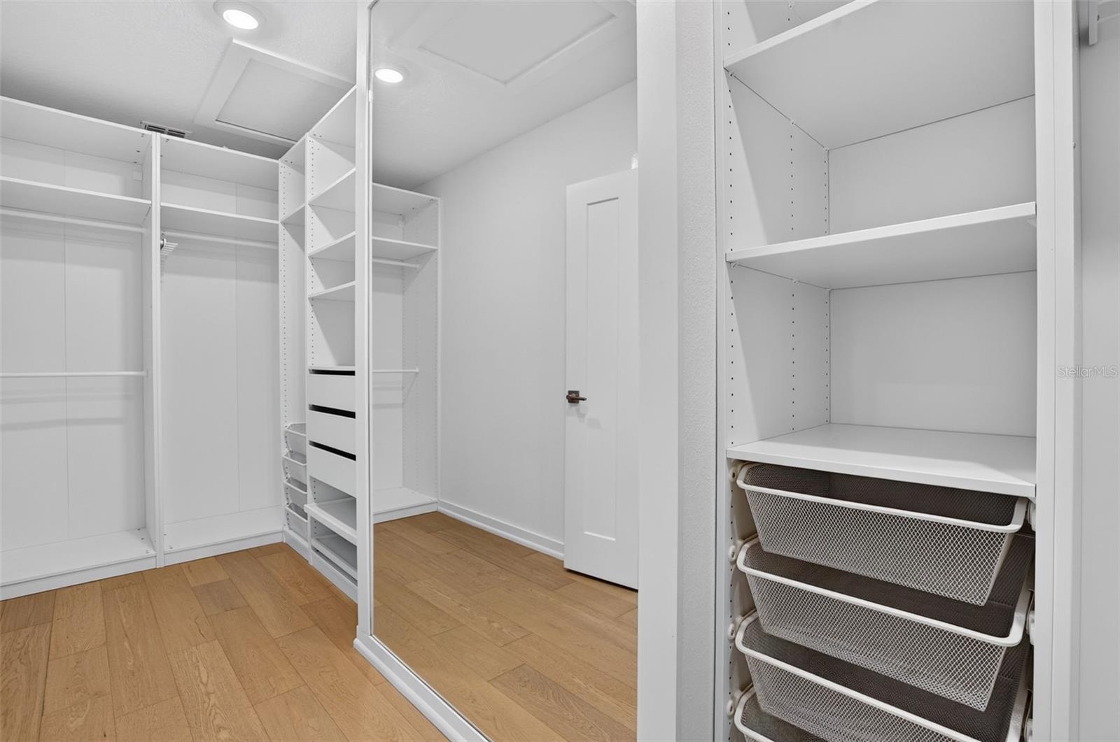 Master Walk In Closet with Built in shelves and drawers.