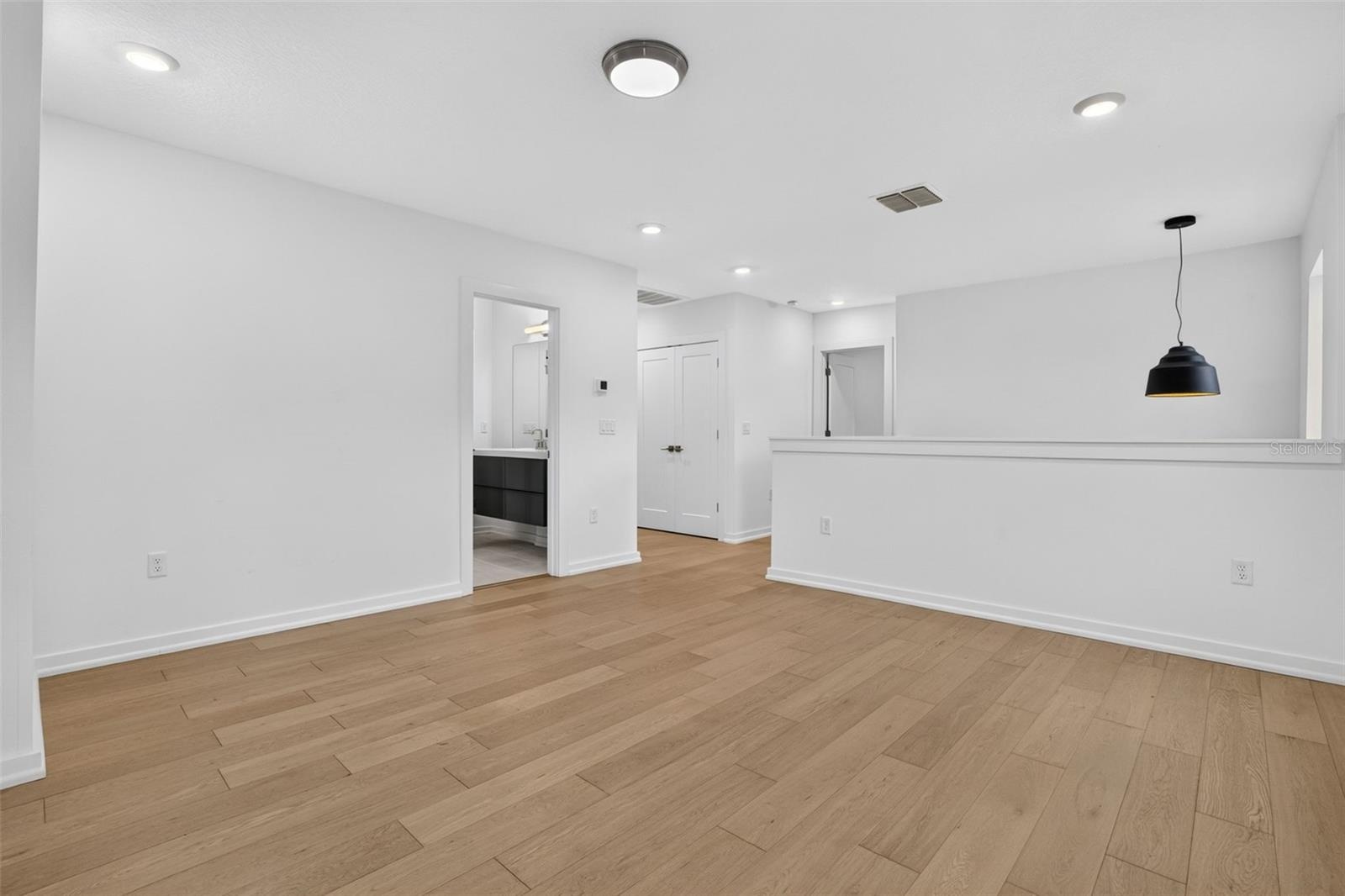 Loft area leads to hallway and access to 3rd bathroom.