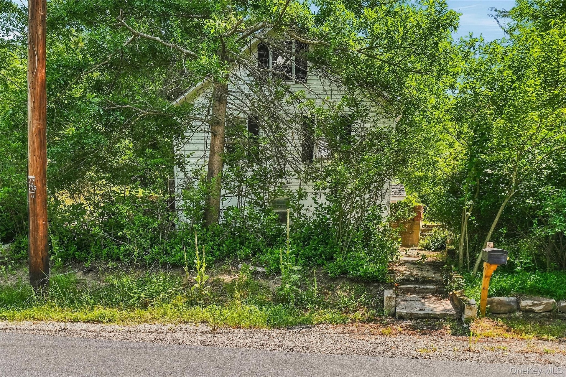 A charming side staircase leads down to the mailbox