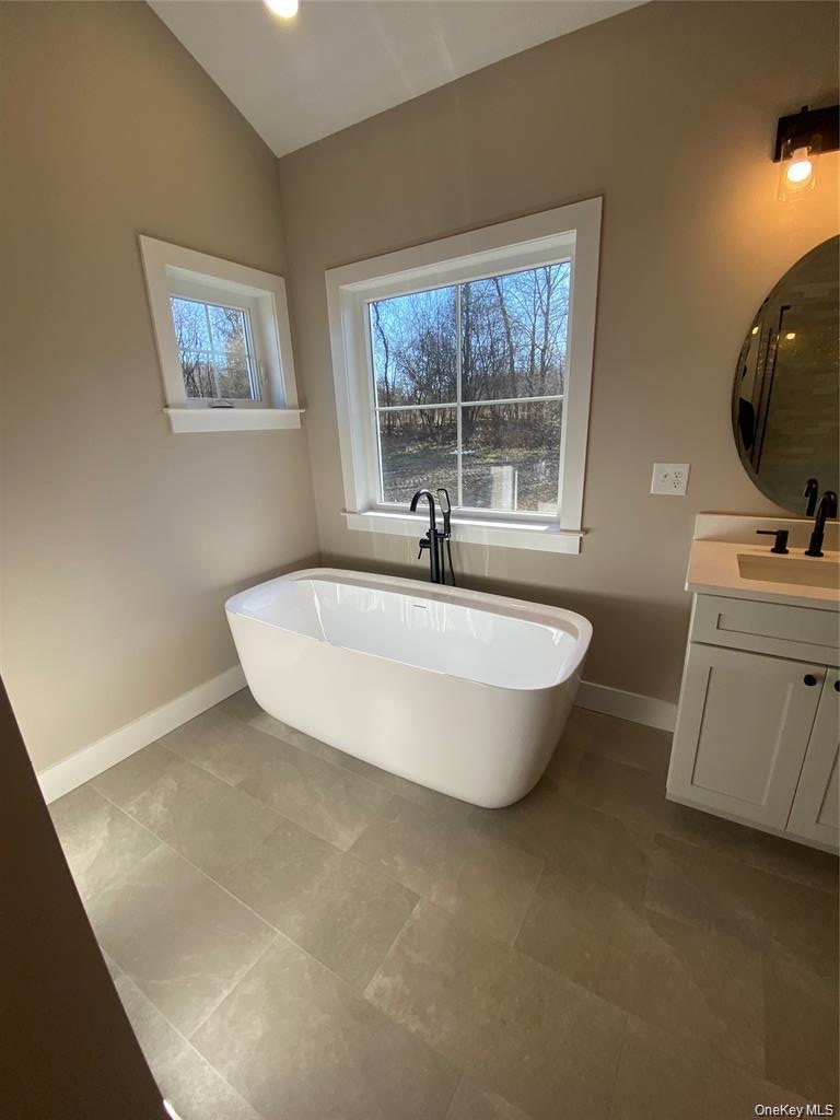 A large free standing soaking tub creates a relaxing sanctuary designed for comfort and tranquility.
