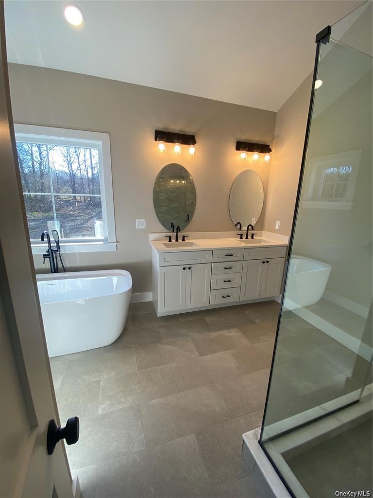 Conveniently located this stylish lower-level master bath features a walk-in shower, custom vanity, contemporary fixtures, and striking designer finis